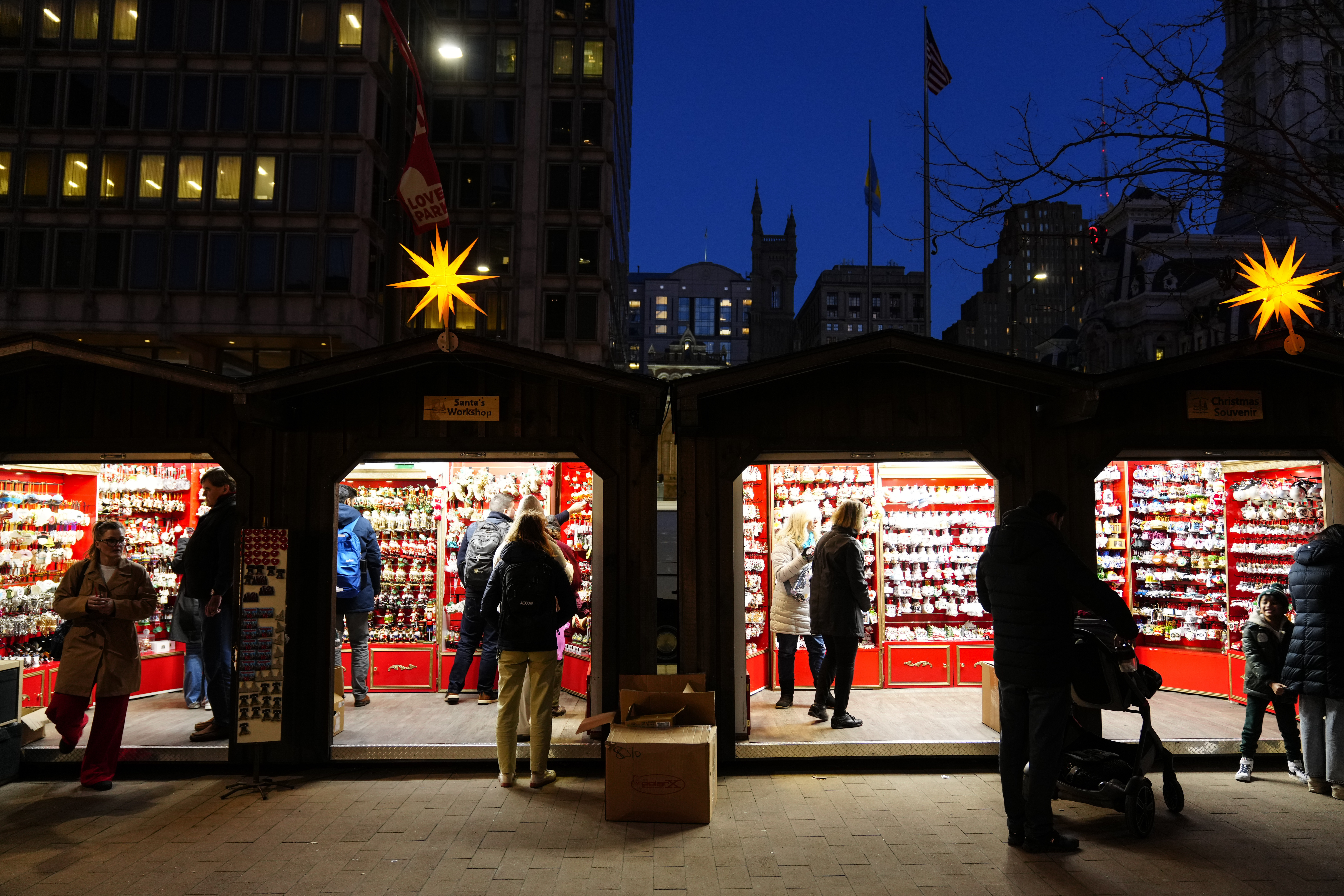 Shoppers visit the Christmas Village in Philadelphia on Dec. 13. Mastercard SpendingPulse said Tuesday that holiday sales rose this year.