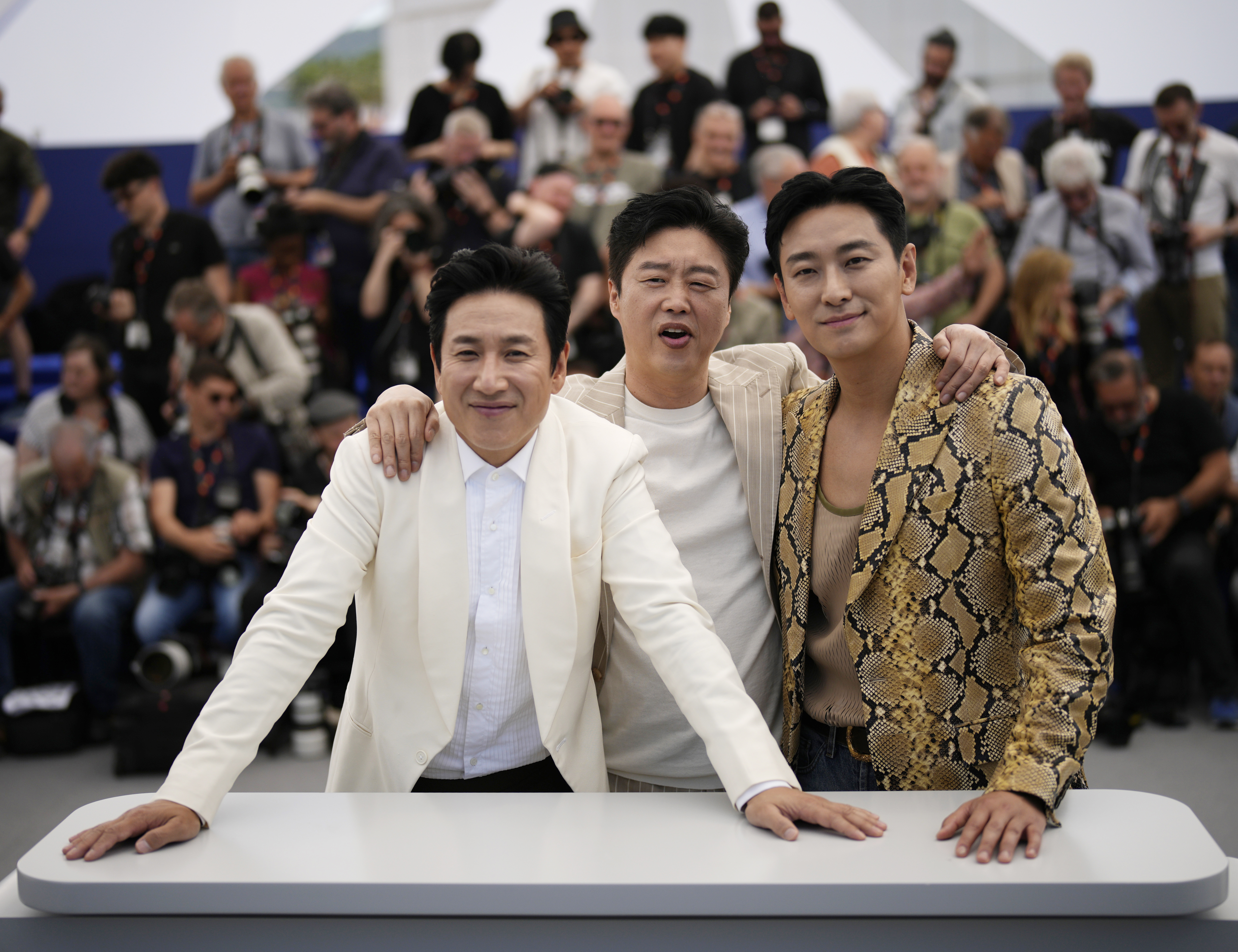 Lee Sun-kyun, from left, Kim Hee-won and Ju Ji-hoon posefor the film 'Project Silence' at the 76th international film festival, Cannes, southern France, on May 22. Sun-kyon was found dead Wednesday in a car at a Seoul park.