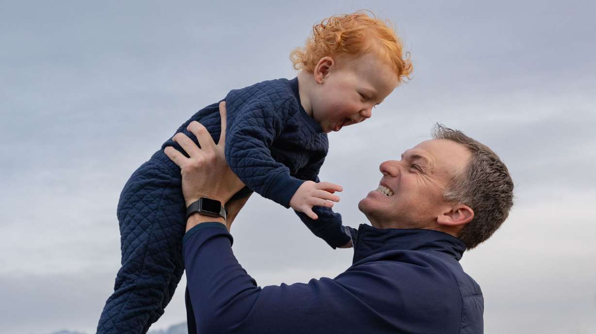 Rep. Blake Moore, R-Utah, holds up his son Franklin, 2, while playing with his children during a photo shoot at Dilworth Elementary School in Salt Lake City on Friday.