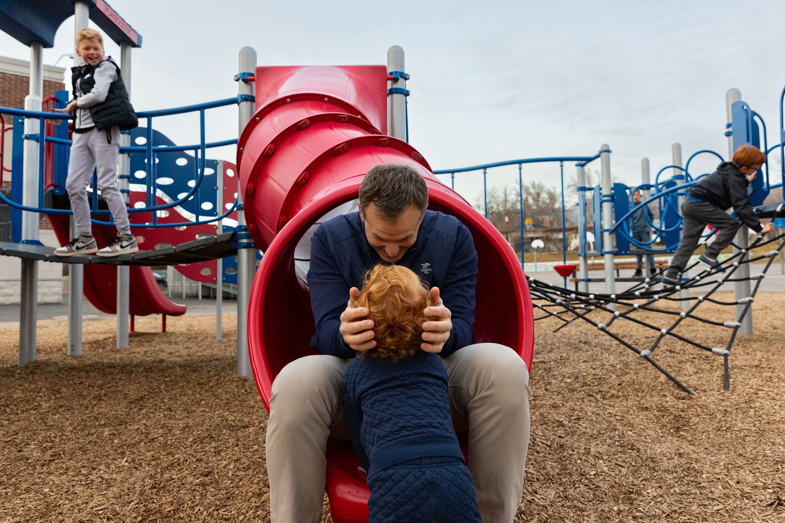 Rep. Blake Moore, R-Utah, hugs his son Franklin, 2, while playing with his children during a photo shoot at Dilworth Elementary School in Salt Lake City on Friday.