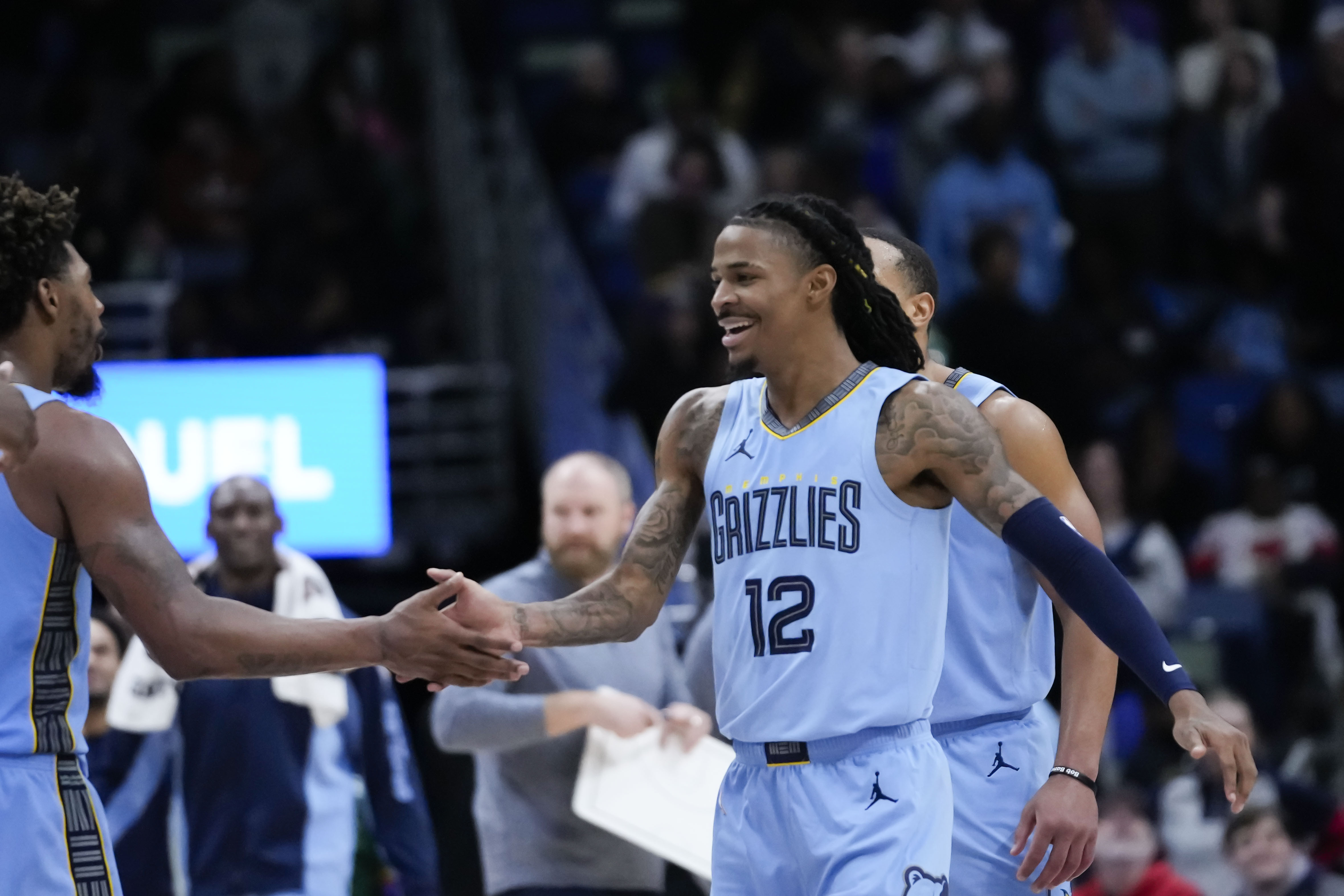 Memphis Grizzlies guard Ja Morant (12) reacts after his slam dunk in the final seconds of overtime during an NBA basketball game in New Orleans, Tuesday, Dec. 26, 2023. The Grizzlies won 116-115. 