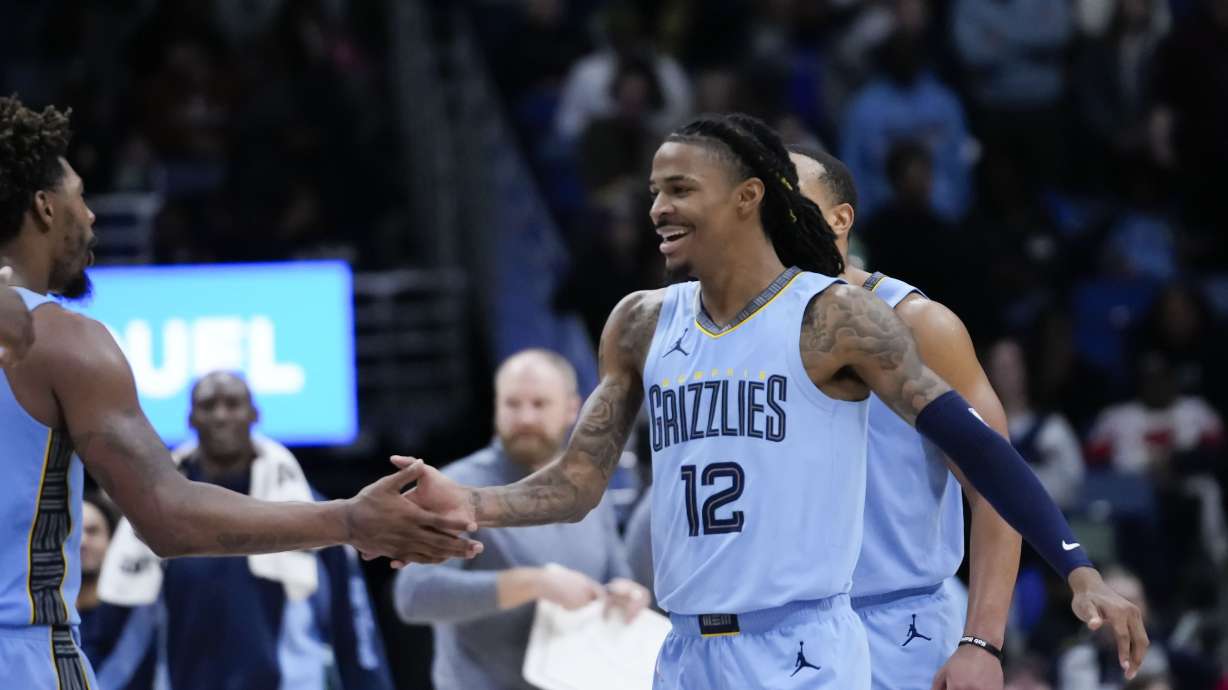 Memphis Grizzlies guard Ja Morant (12) reacts after his slam dunk in the final seconds of overtime during an NBA basketball game in New Orleans, Tuesday, Dec. 26, 2023. The Grizzlies won 116-115.