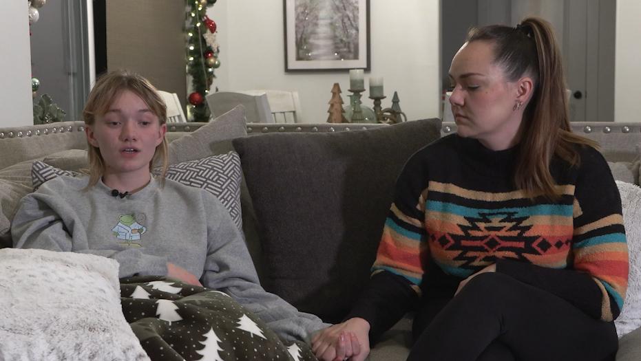 Sammie Bronson holds her mother’s hand while talking about her Christmas Day car crash.