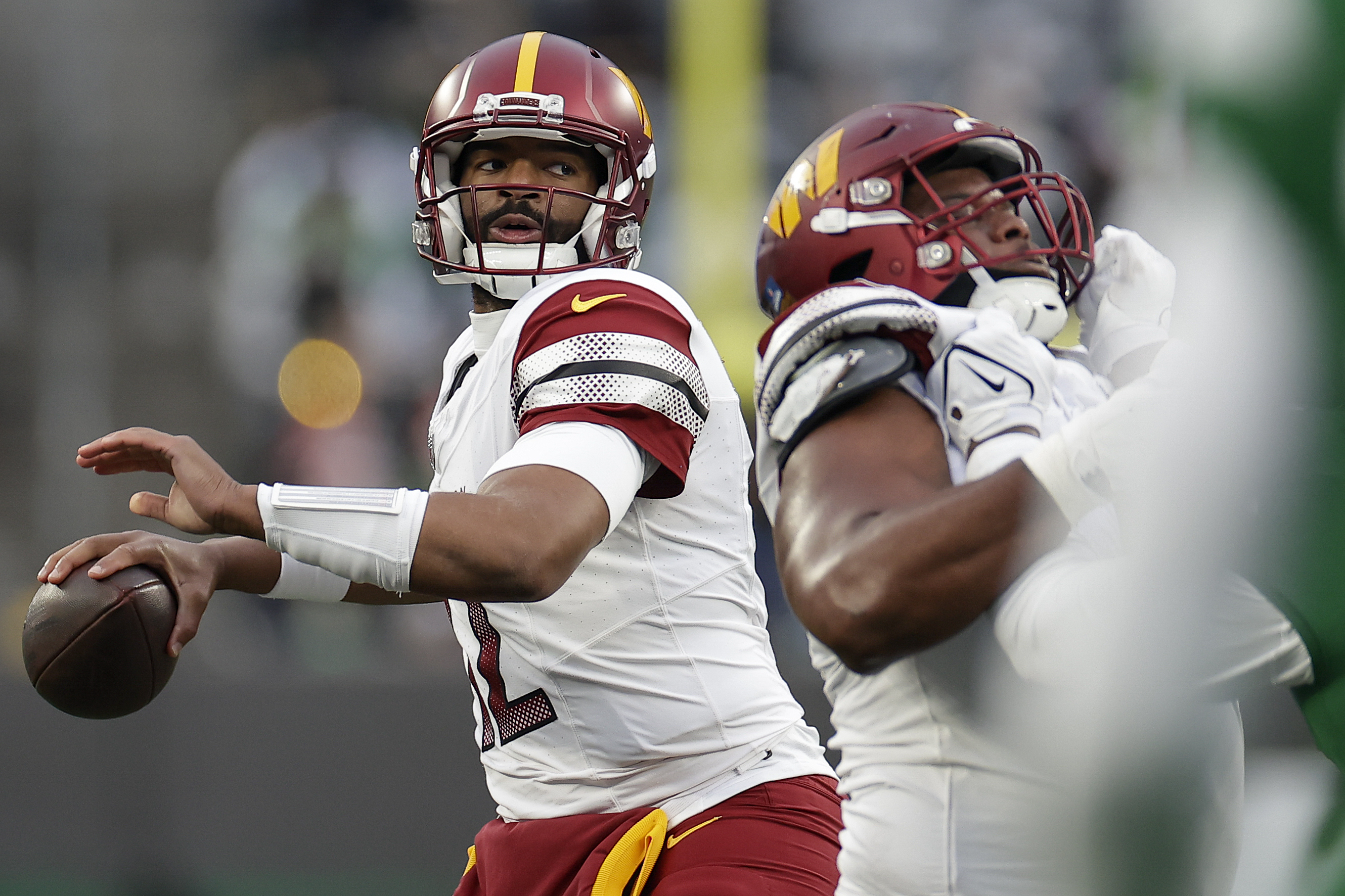 Washington Commanders quarterback Jacoby Brissett (12) passes against the New York Jets during the third quarter of an NFL football game, Sunday, Dec. 24, 2023, in East Rutherford, N.J.