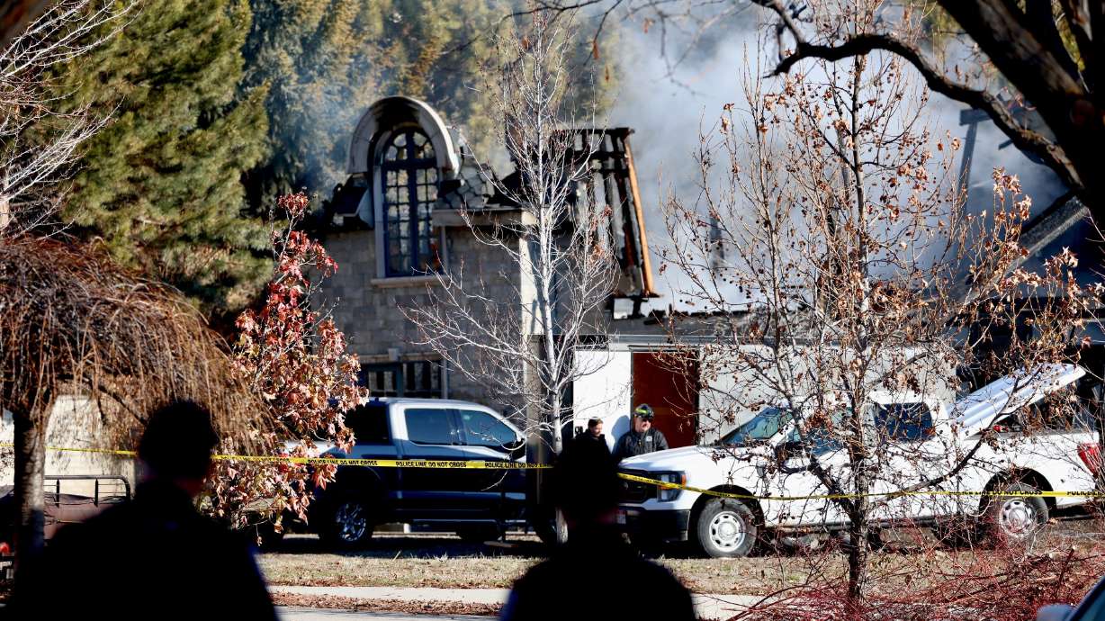 Firefighters survey the scene of a house fire in Orem on Dec. 27, 2023, a day after the 27,000-square-foot home was destroyed. Orem police have requested to collect additional evidence.