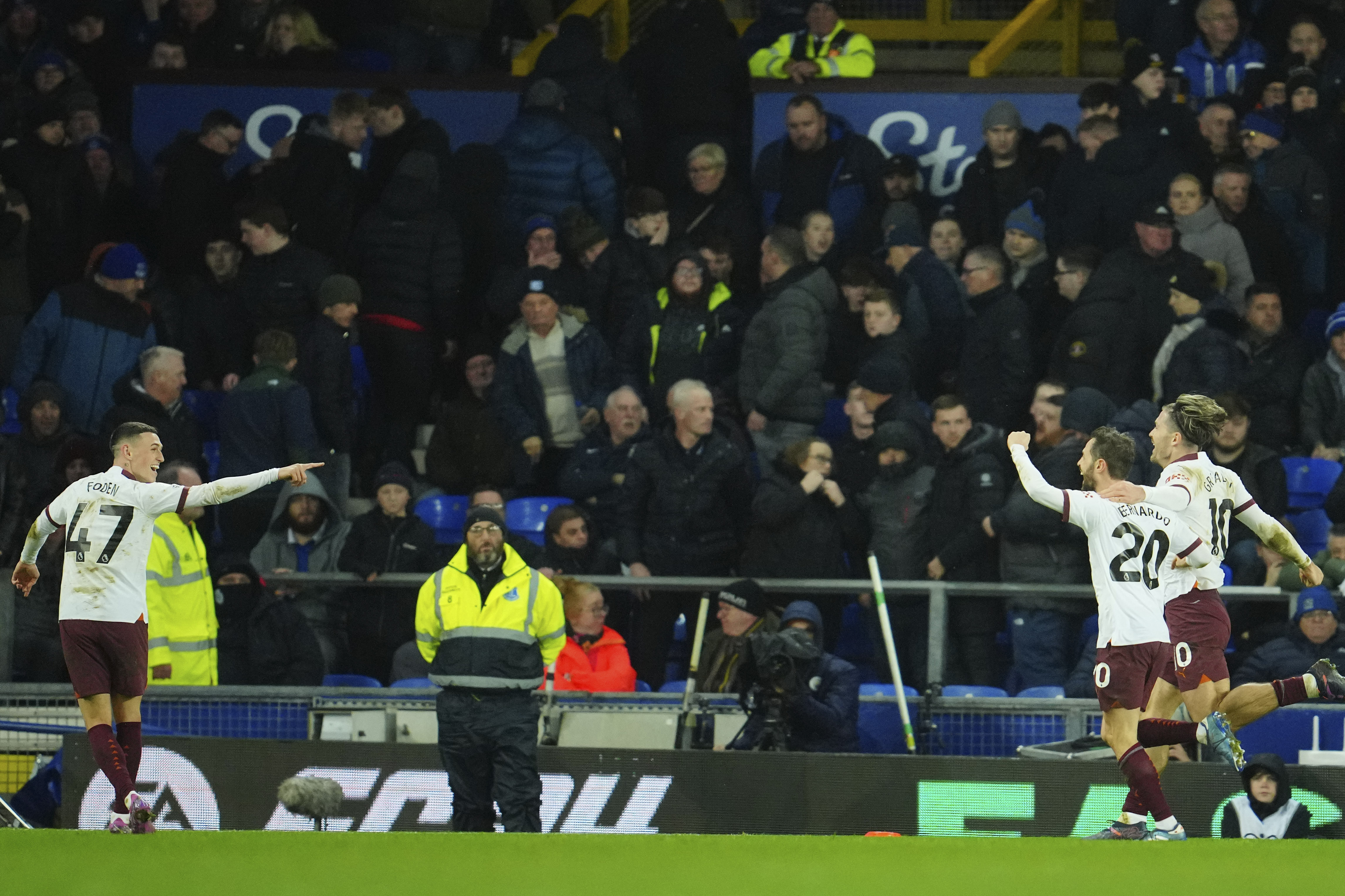 Manchester City's Bernardo Silva, second right, celebrates after scoring his sides third goal during the English Premier League soccer match between Everton and Manchester City at Goodison Park stadium in Liverpool, England, Wednesday, Dec. 27, 2023. 