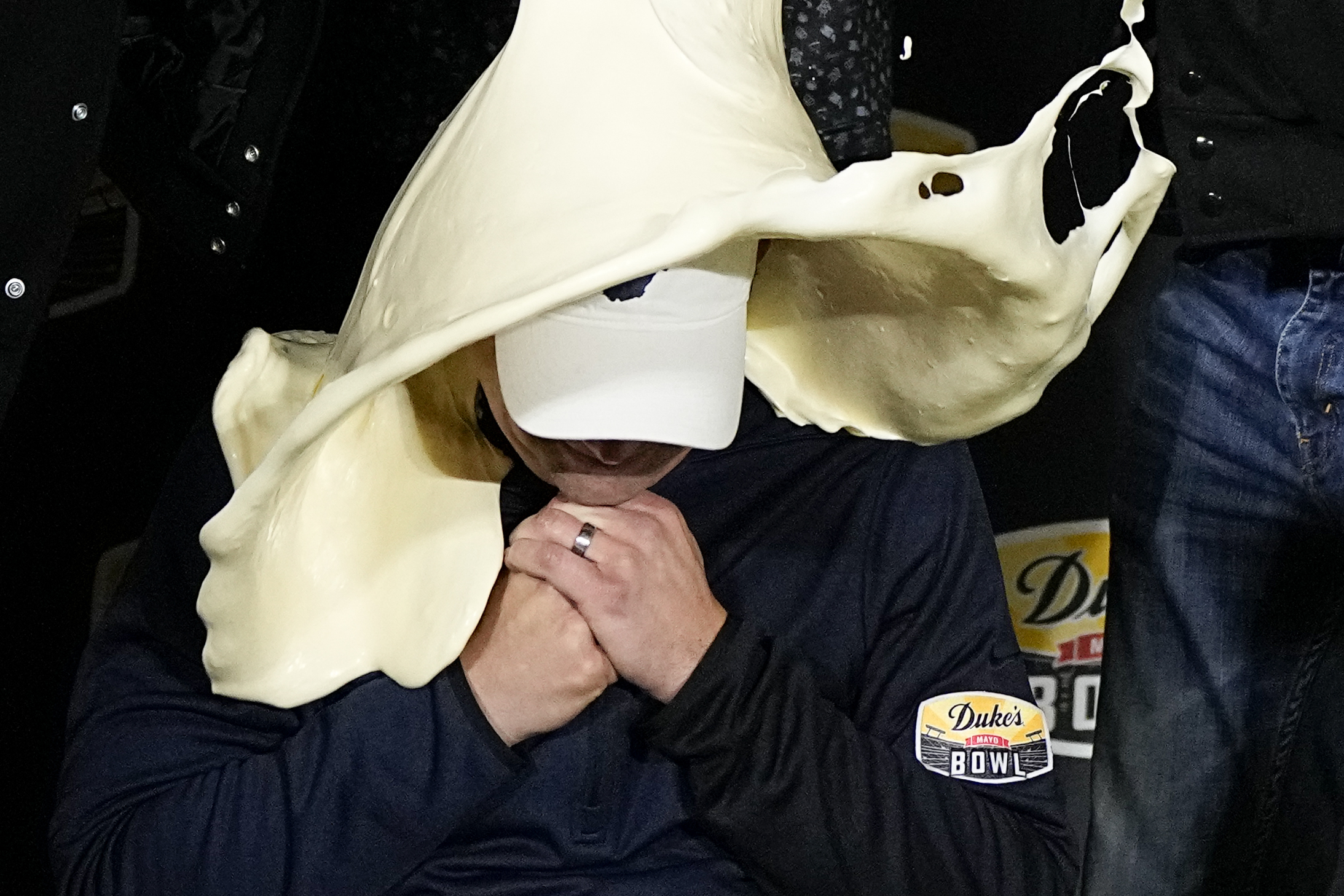 West Virginia head coach Neal Brown gets dunked with mayonnaise after their win against North Carolina in an NCAA college football game at the Duke's Mayo Bowl Wednesday, Dec. 27, 2023, in Charlotte, N.C. 