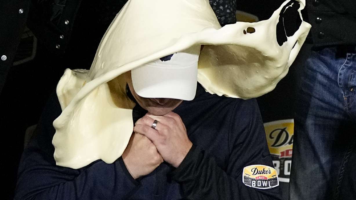 West Virginia head coach Neal Brown gets dunked with mayonnaise after their win against North Carolina in an NCAA college football game at the Duke's Mayo Bowl Wednesday, Dec. 27, 2023, in Charlotte, N.C.