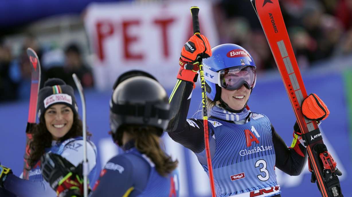 United States' Mikaela Shiffrin, right, celebrates winning an alpine ski, women's World Cup giant slalom race, as second-placed Italy's Federica Brignone, left, and third-placed Sweden's Sara Hector, smile, in Lienz, Austria, Thursday, Dec. 28, 2023.