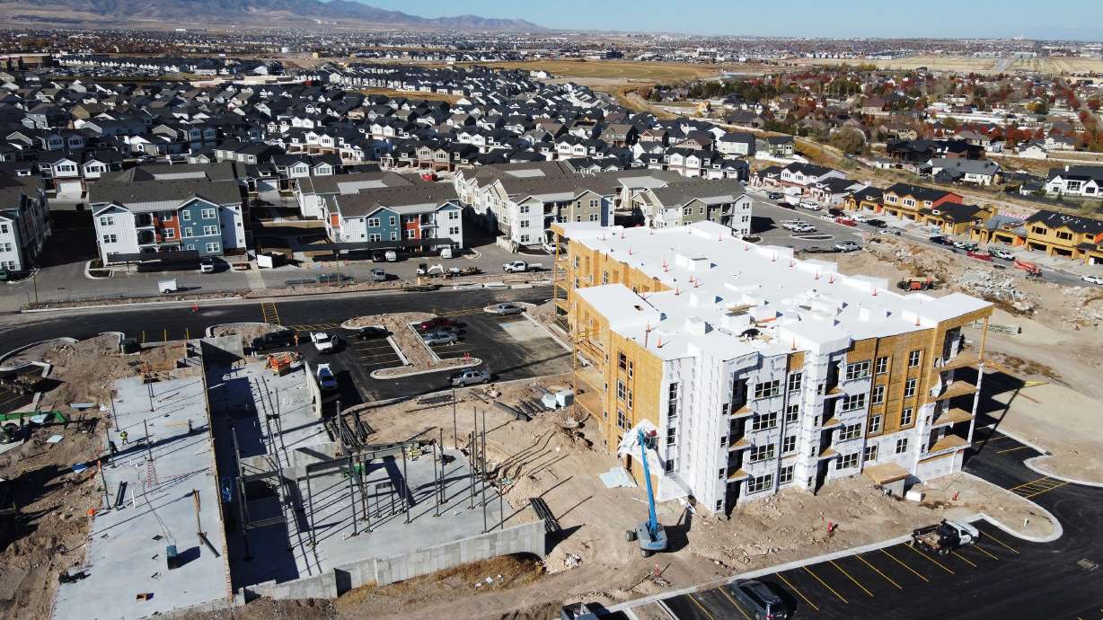 Crews work on constructing town homes and apartments in Herriman on Nov. 14.
