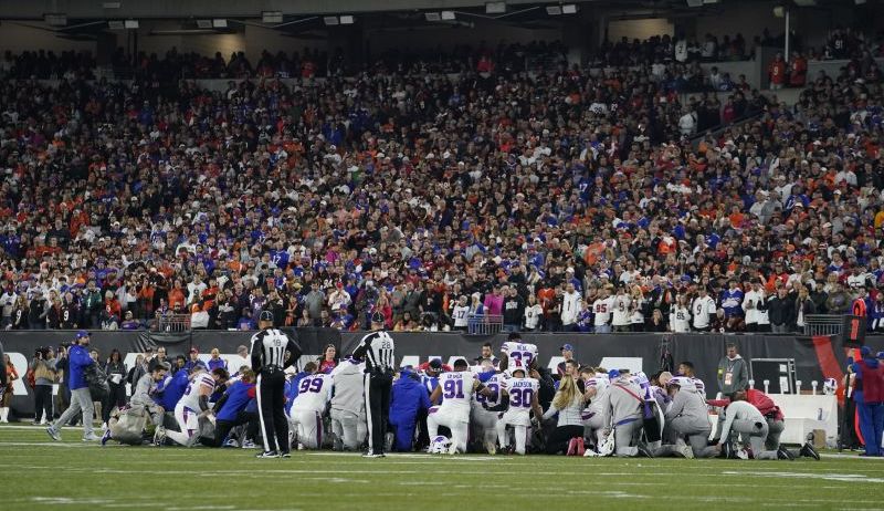 The Buffalo Bills players pray for teammate Damar Hamlin during the first half of an NFL football game against the Cincinnati Bengals in Cincinnati.