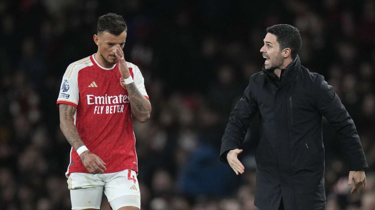 Arsenal's manager Mikel Arteta, right, and Arsenal's Ben White, left, during the English Premier League soccer match between Arsenal and West Ham at Emirates stadium in London, England, Thursday, Dec. 28, 2023.