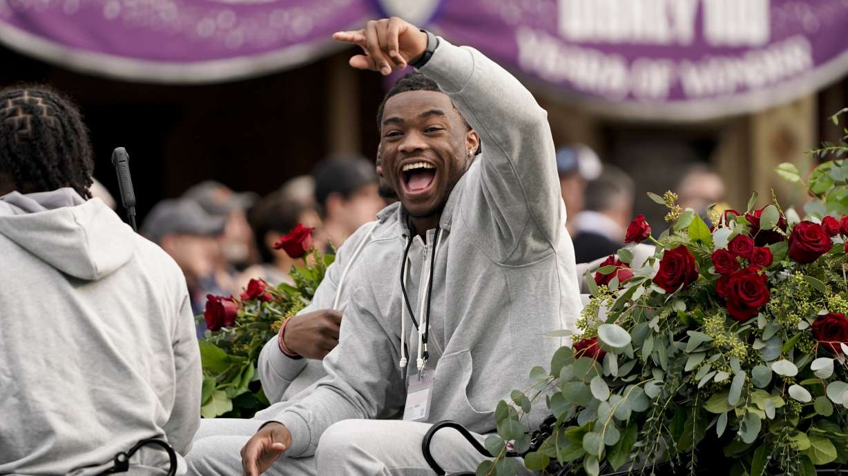 Alabama quarterback Jalen Milroe waves during a welcome event at Disneyland on Wednesday, Dec. 27, 2023, in Anaheim, Calif. Alabama is scheduled to play against Michigan on New Year's Day in the Rose Bowl, a semifinal in the College Football Playoff.