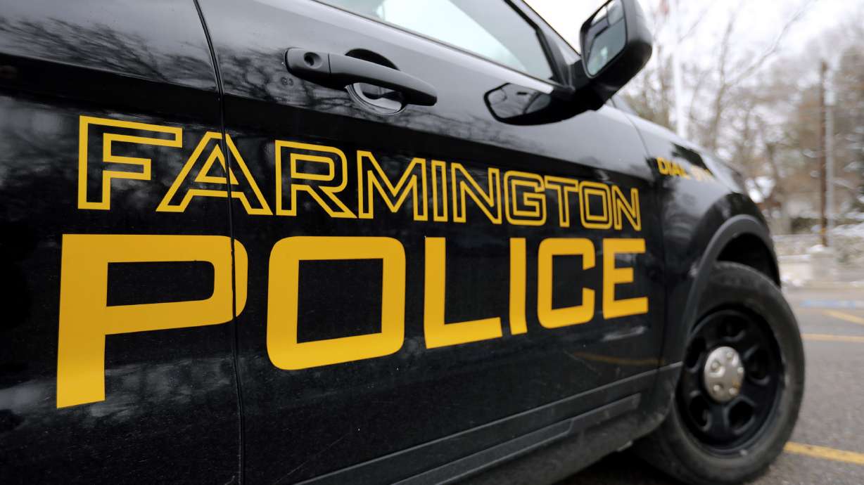 A man was shot and killed by police in Farmington early Monday after officers were called to a report of a man holding a gun to a woman's head.