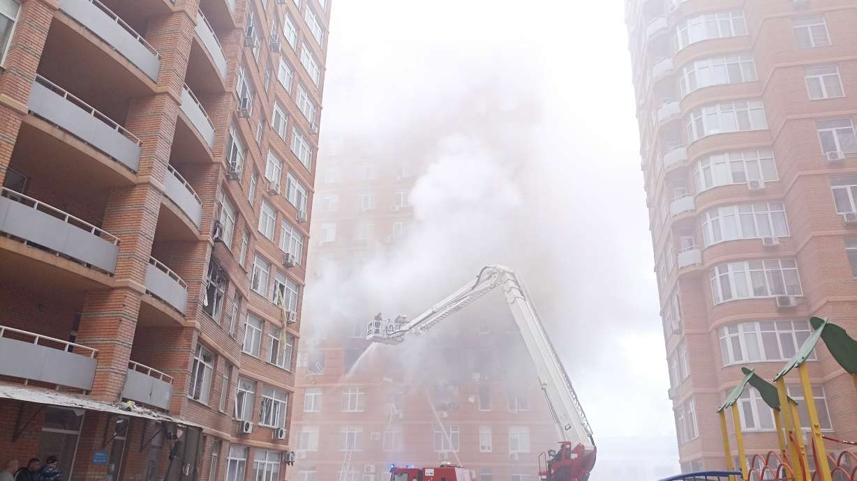 Firefighters work to extinguish a fire at a damaged apartment building after a Russian attack in Odesa, Ukraine, Friday. Officials say Russia has launched 122 missiles and dozens of drones against Ukrainian targets, killing at least 30 civilians in what an air force official calls the biggest aerial barrage of the war.