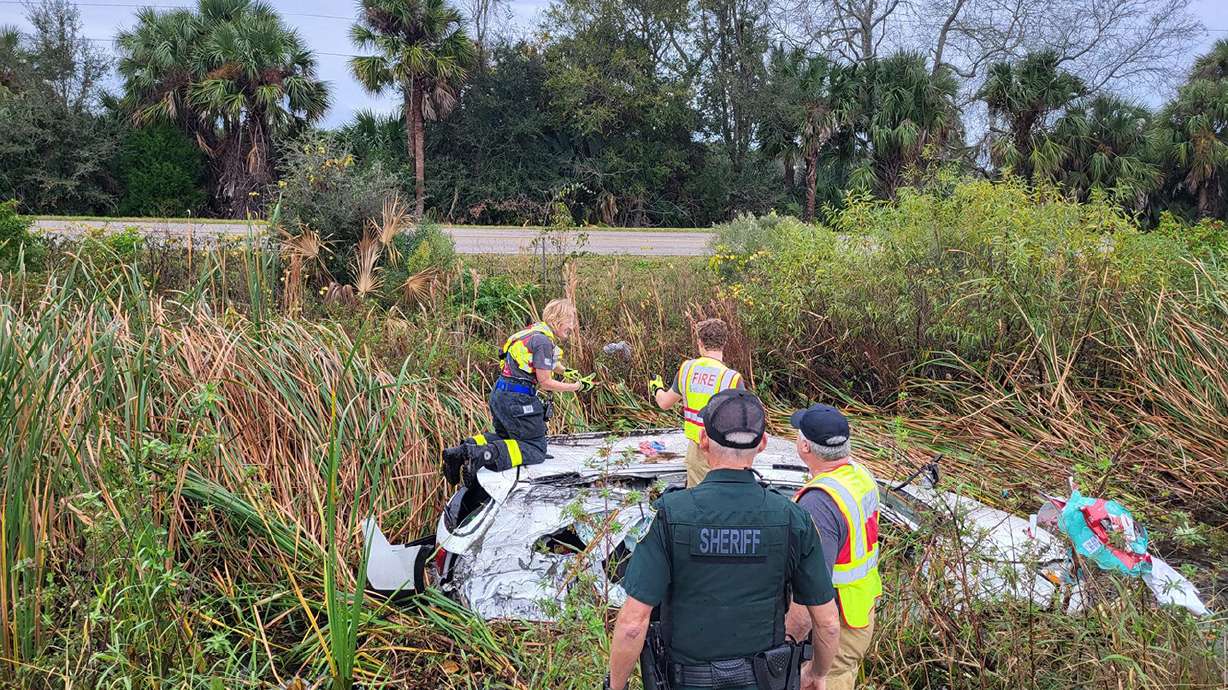 First responders rescue Christmas gifts from a family's car that crashed on Christmas day in northeastern Florida.