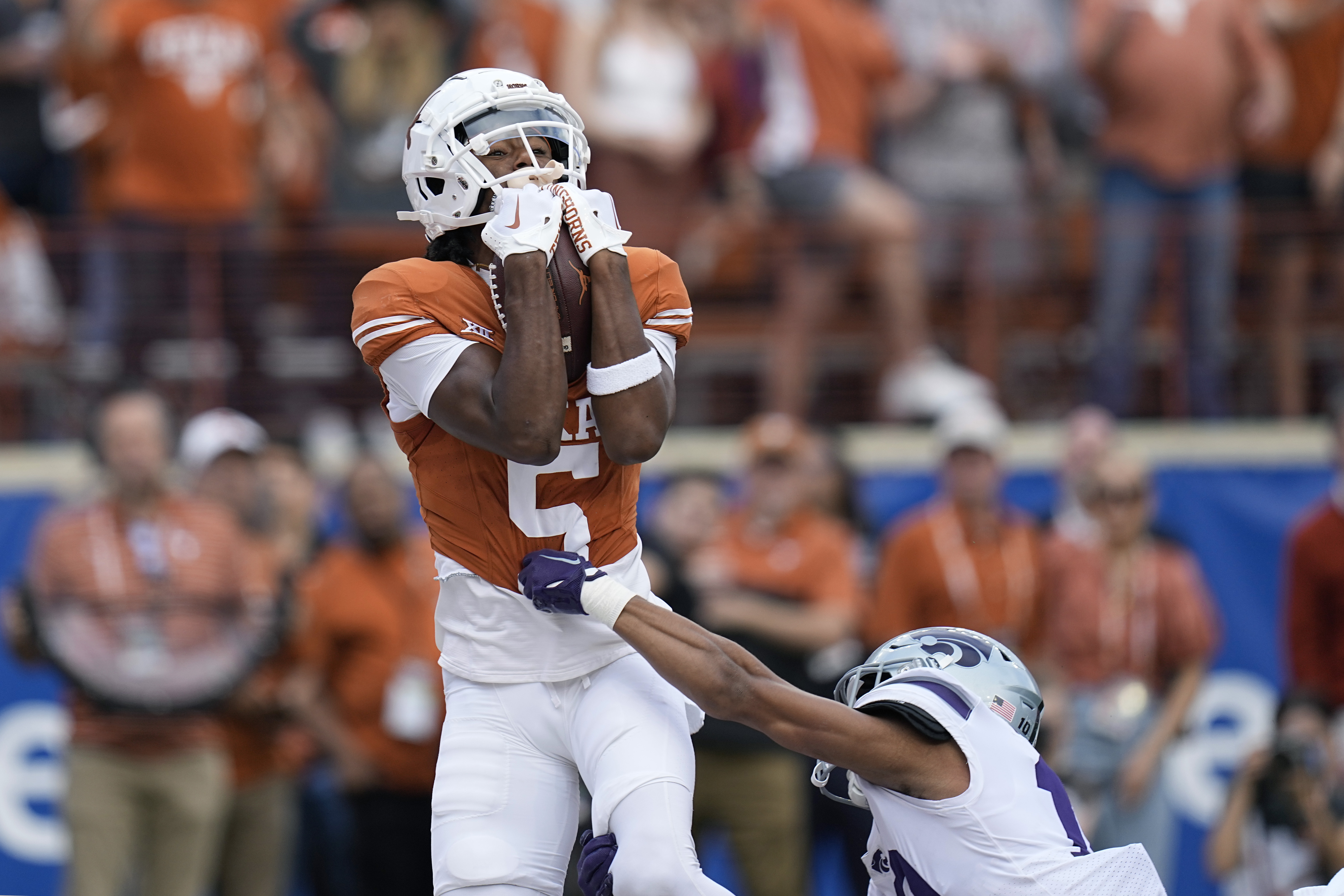 FILE - Texas wide receiver Adonai Mitchell (5) makes a touchdown catch over Kansas State cornerback Jacob Parrish (10) during the first half of an NCAA college football game in Austin, Texas, Saturday, Nov. 4, 2023. Mitchell was selected as the Big 12 newcomer of the year. 