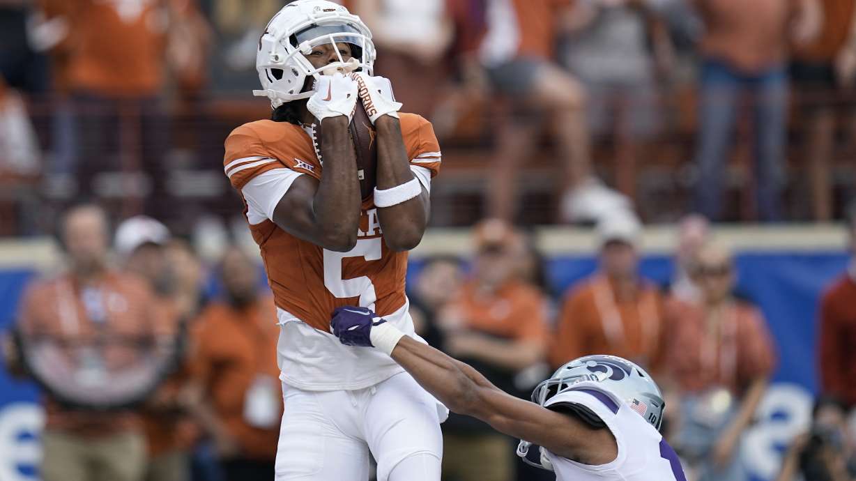 FILE - Texas wide receiver Adonai Mitchell (5) makes a touchdown catch over Kansas State cornerback Jacob Parrish (10) during the first half of an NCAA college football game in Austin, Texas, Saturday, Nov. 4, 2023. Mitchell was selected as the Big 12 newcomer of the year.