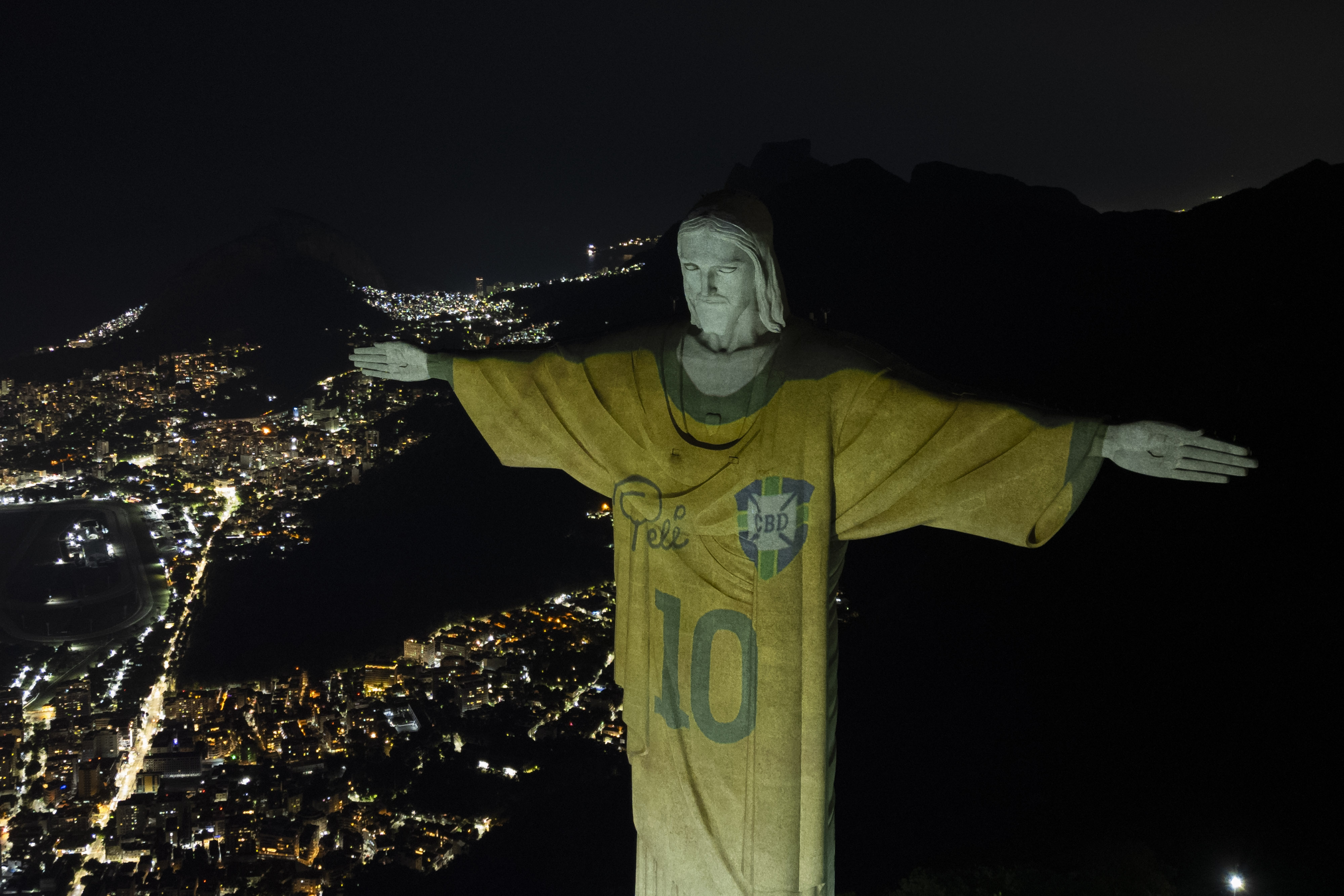 The Christ the Redeemer statue is illuminated with an image of Pele's Brazilian jersey, as a tribute to the soccer legend on his one-year death anniversary, in Rio de Janeiro, Brazil, Friday, Dec. 29, 2023. 