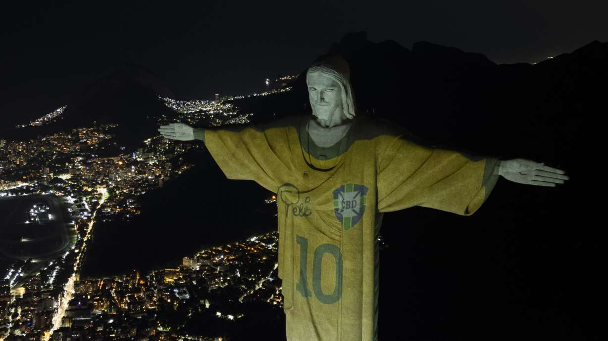 The Christ the Redeemer statue is illuminated with an image of Pele's Brazilian jersey, as a tribute to the soccer legend on his one-year death anniversary, in Rio de Janeiro, Brazil, Friday, Dec. 29, 2023.