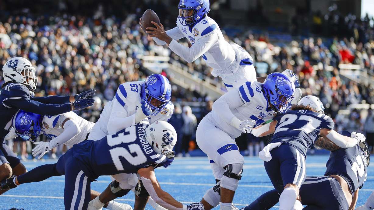 Georgia State quarterback Darren Grainger (3) jumps over the goal line for a touchdown against Utah State in the first half of the Famous Idaho Potato Bowl NCAA college football game, Saturday, Dec. 23, 2023, in Boise, Idaho.