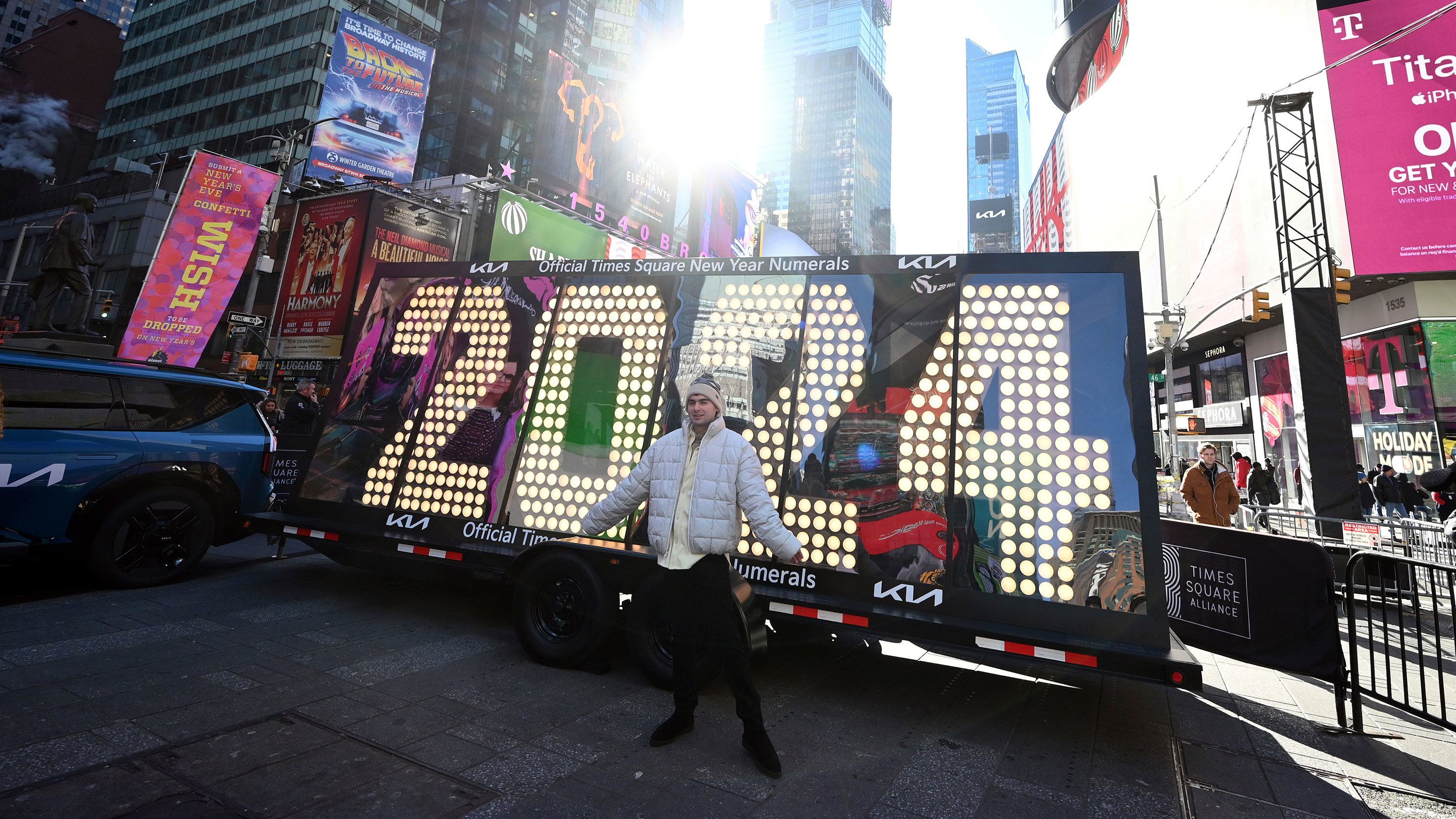People pose in front of the 2024 New Year's Eve numerals after the illumination ceremony in Times Square on December 20.