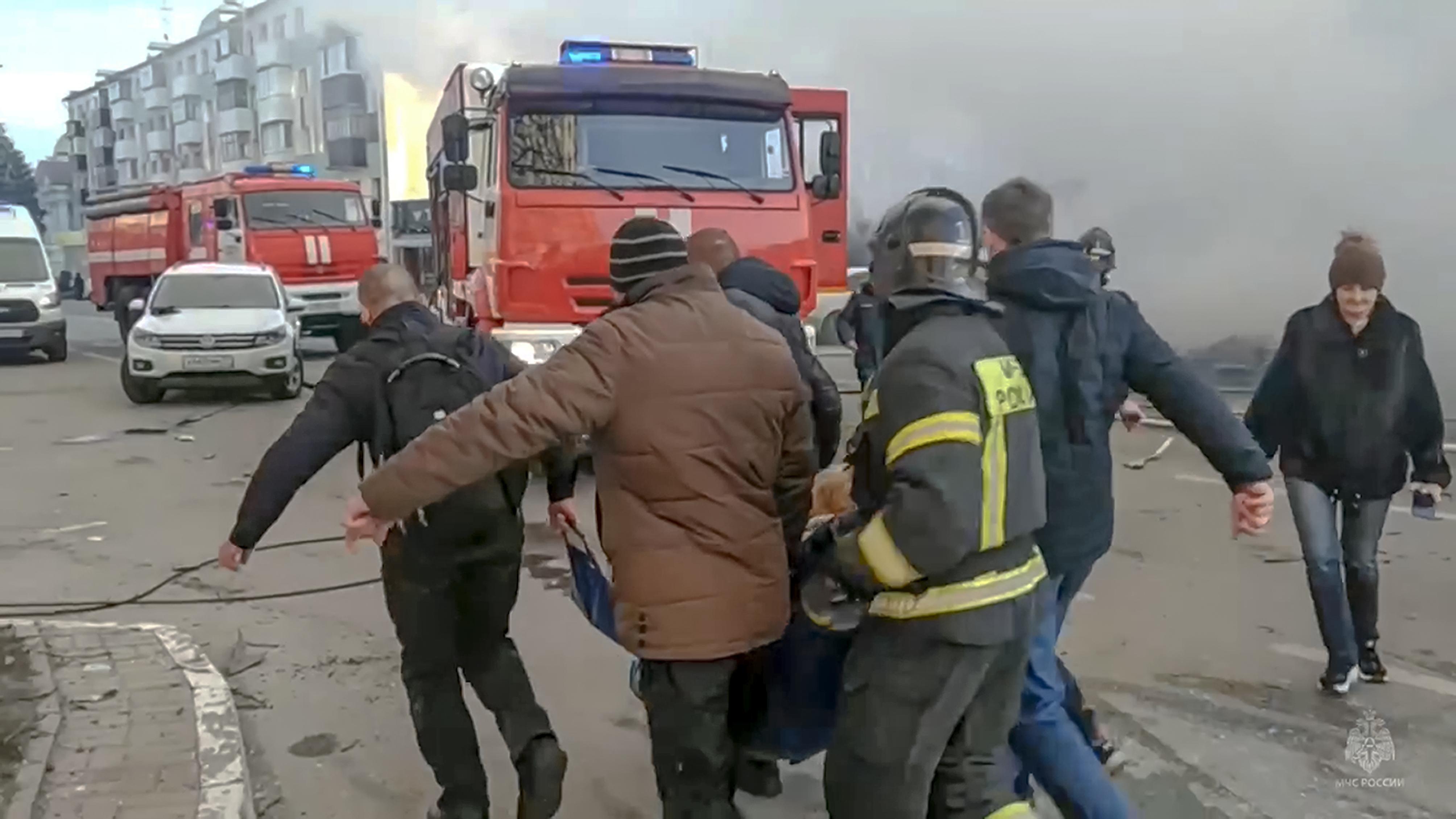 In this photo taken from video released by Russia Emergency Situations Ministry telegram channel on Saturday. Rescuers and people carry a wounded person after shelling in Belgorod, Russia.