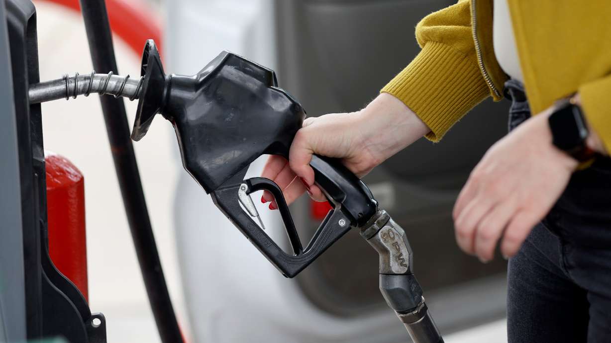 A woman gets gas at Shoppers Express in Salt Lake City on Sept. 13. Utah's gas prices remain about 25 cents below the national average as 2023 comes to an end; however, AAA says the price slide is expected to end in early 2024.