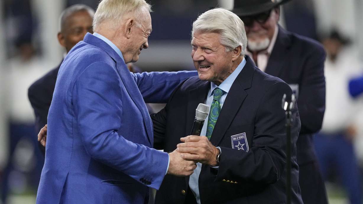 Dallas Cowboys owner Jerry Jones, left, talks with Pro Football Hall of Fame coach Jimmy Johnson after Johnson was inducted into the team's ring of honor during a ceremony at halftime of an NFL football game against the Detroit Lions, Saturday, Dec. 30, 2023, in Arlington, Texas.