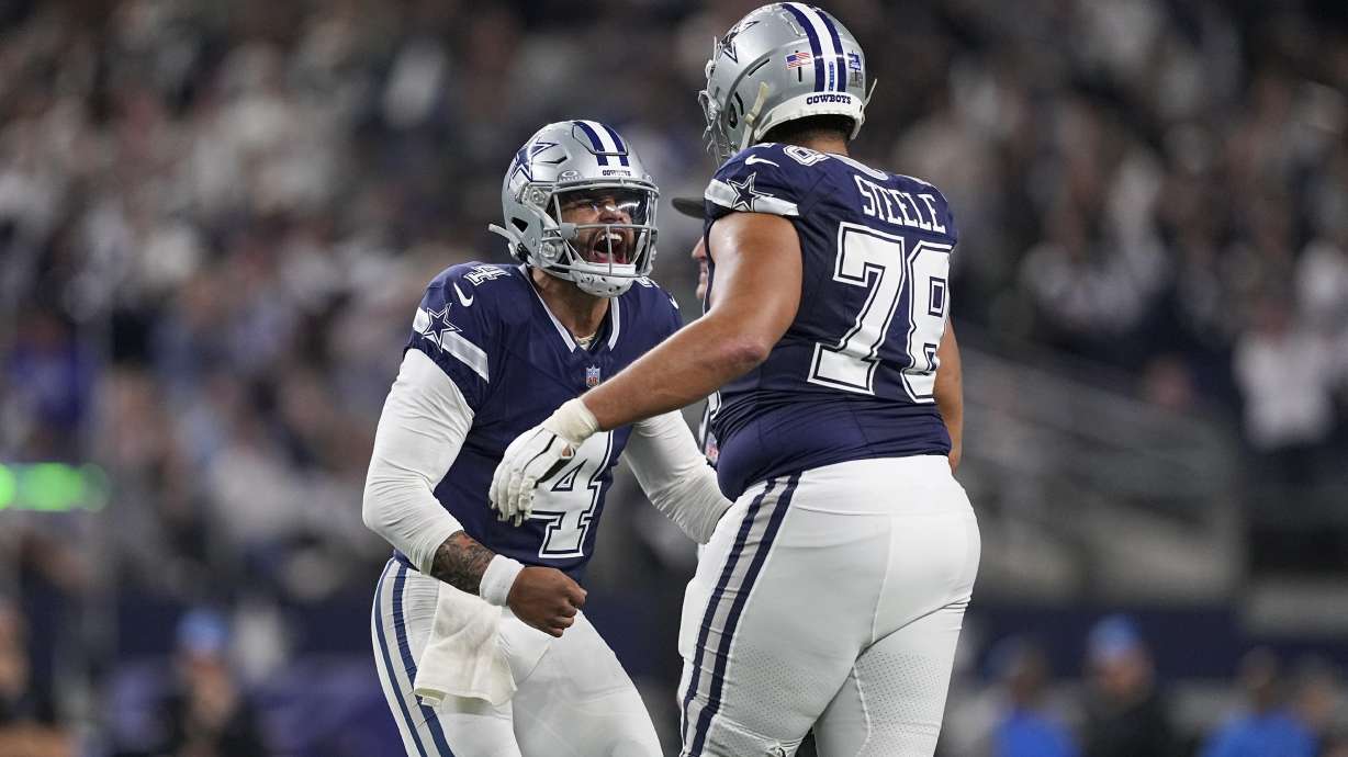 Dallas Cowboys quarterback Dak Prescott (4) reacts with offensive tackle Terence Steele (78) after throwing a touchdown pass against the Detroit Lions during the second half of an NFL football game, Saturday, Dec. 30, 2023, in Arlington, Texas.