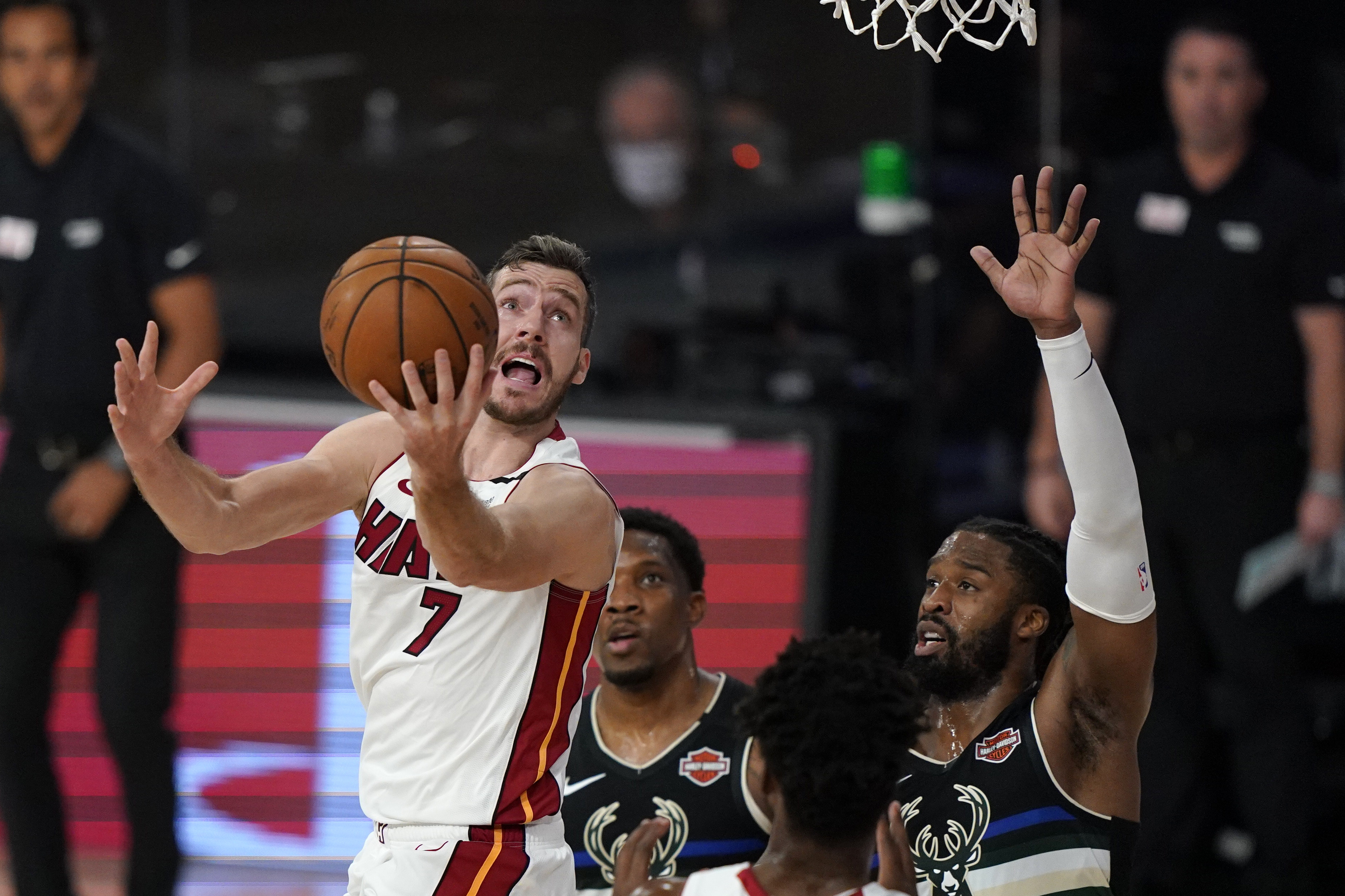 FILE - Miami Heat's Goran Dragic (7) puts up a shot against Milwaukee Bucks' Wesley Matthews (9), right, during the first half an NBA conference semifinal playoff basketball game Wednesday, Sept. 2, 2020, in Lake Buena Vista, USA. Goran Dragic, a former All-Star guard with the Miami Heat and the leader of Slovenia’s team that won the EuroBasket championship in 2017, has announced his retirement.