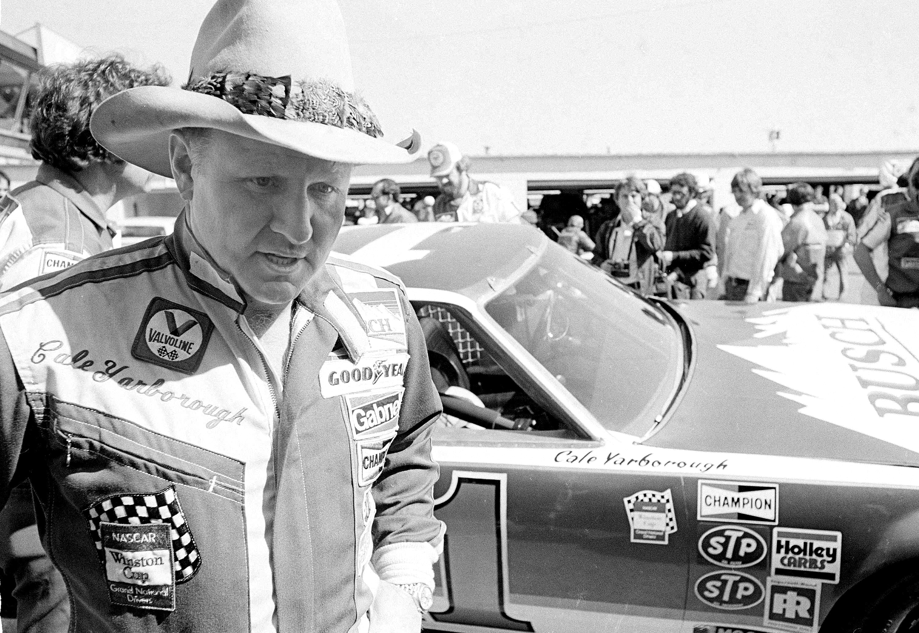 FILE - Cale Yarborough walks away after blowing the engine of his Oldsmobile just after completing his first lap in pole position qualifying for the Daytona 500 in Daytona Beach, Fla., Feb. 11, 1979. Yarborough, considered one of NASCAR's all-time greatest drivers and the first to win three consecutive Cup titles, died Sunday, Dec. 31, 2023. He was 84. 