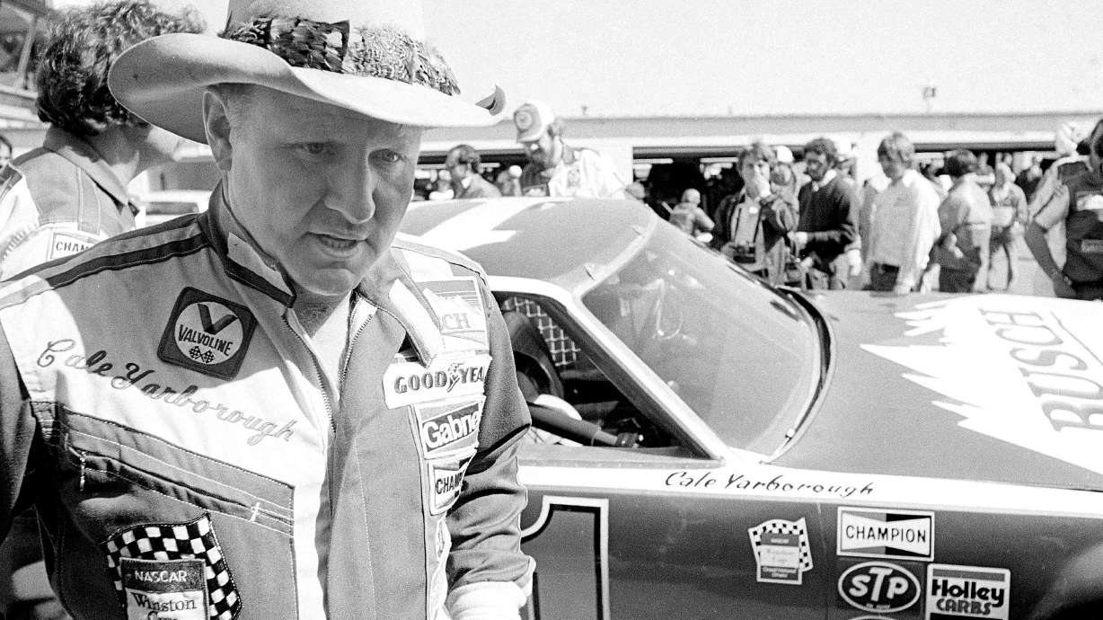 FILE - Cale Yarborough walks away after blowing the engine of his Oldsmobile just after completing his first lap in pole position qualifying for the Daytona 500 in Daytona Beach, Fla., Feb. 11, 1979. Yarborough, considered one of NASCAR's all-time greatest drivers and the first to win three consecutive Cup titles, died Sunday, Dec. 31, 2023. He was 84.
