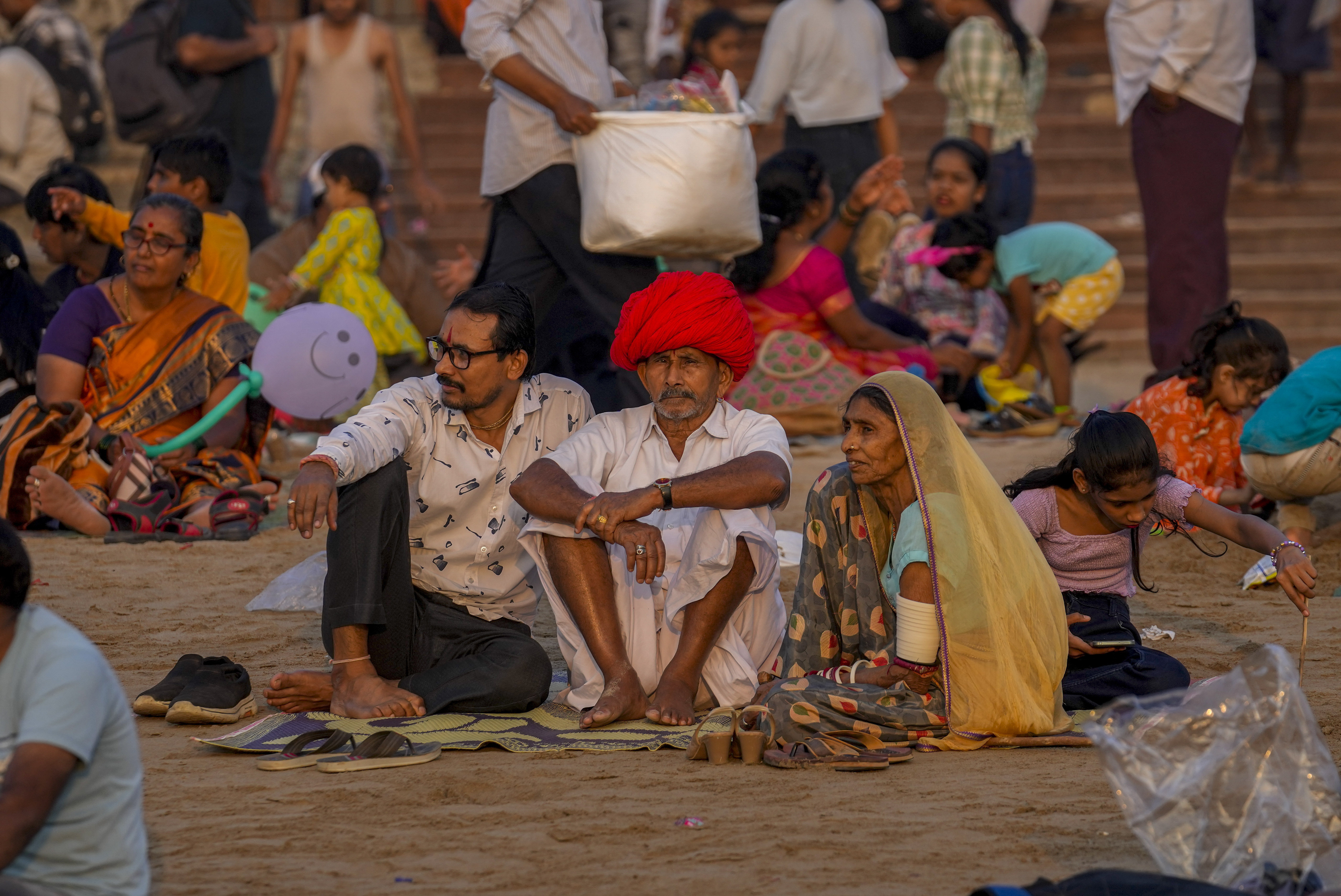 People gather at the Juhu Beach on the Arabian Sea coast on New Year's Eve in Mumbai, India, Sunday.
