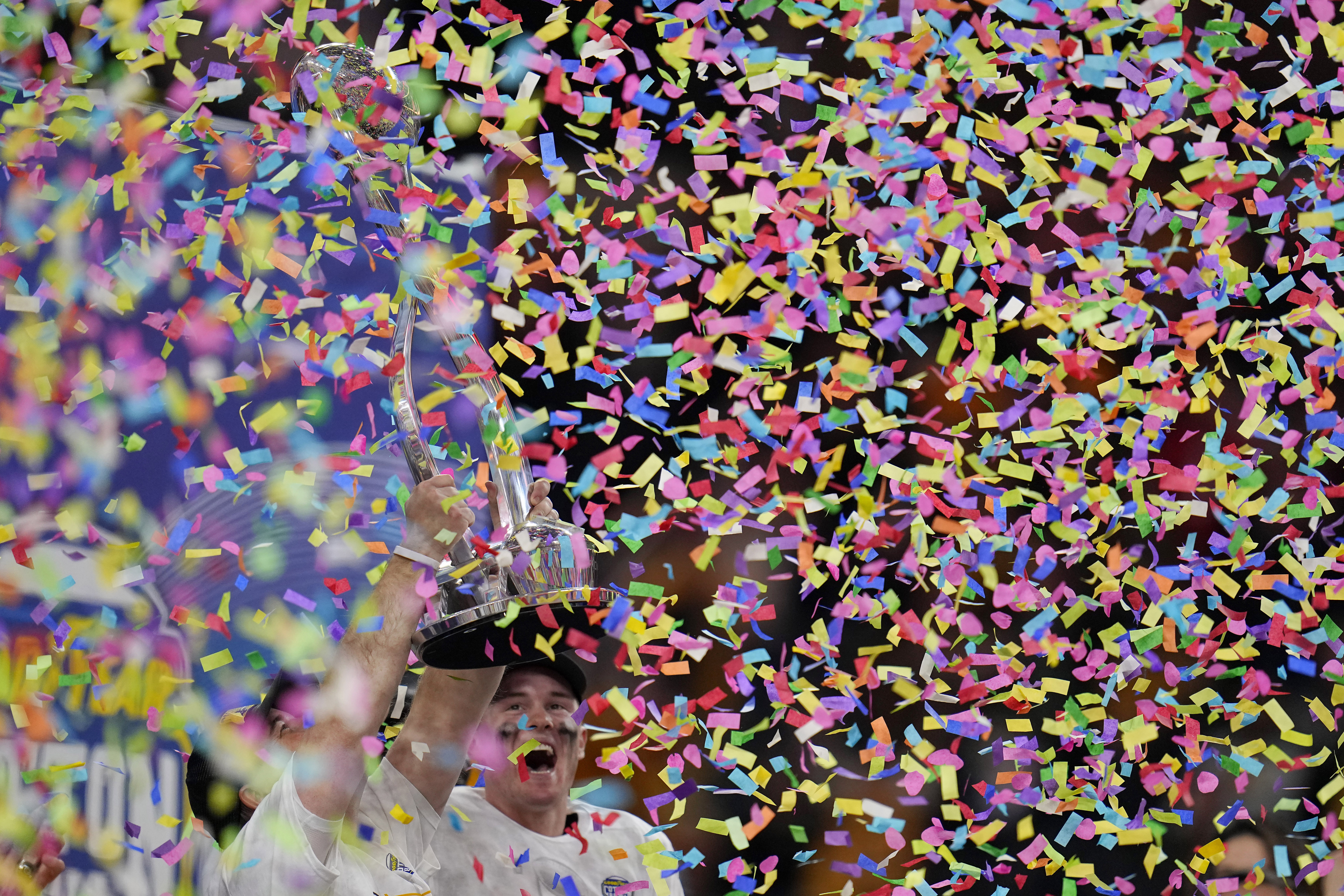 Missouri coach Eliah Drinkwitz, bottom left, and quarterback Brady Cook celebrate the team's win over Ohio State in the Cotton Bowl NCAA college football game Friday, Dec. 29, 2023, in Arlington, Texas.