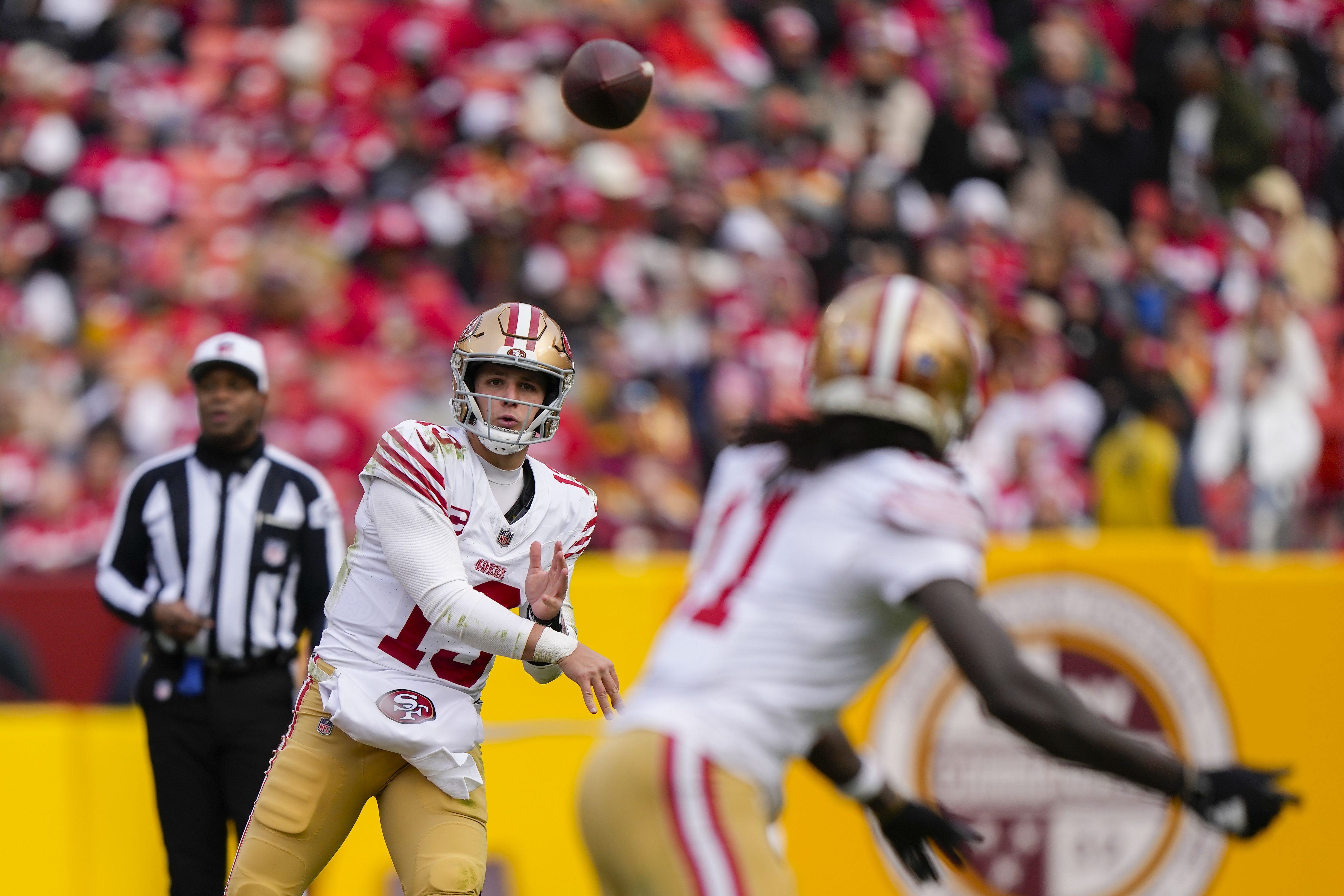 San Francisco 49ers quarterback Brock Purdy (13) throwing a pass to wide receiver Brandon Aiyuk (11) during the second half of an NFL football game, Sunday, Dec. 31, 2023, in Landover, Md. 