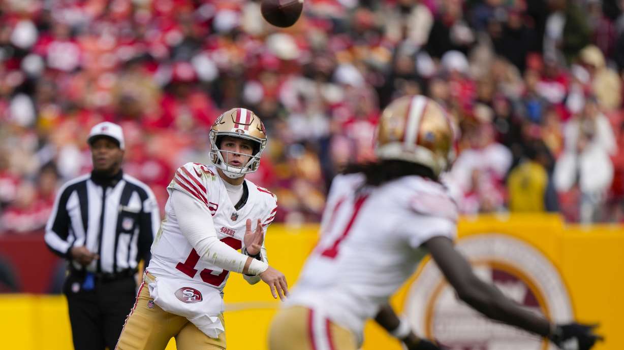 San Francisco 49ers quarterback Brock Purdy (13) throwing a pass to wide receiver Brandon Aiyuk (11) during the second half of an NFL football game, Sunday, Dec. 31, 2023, in Landover, Md.
