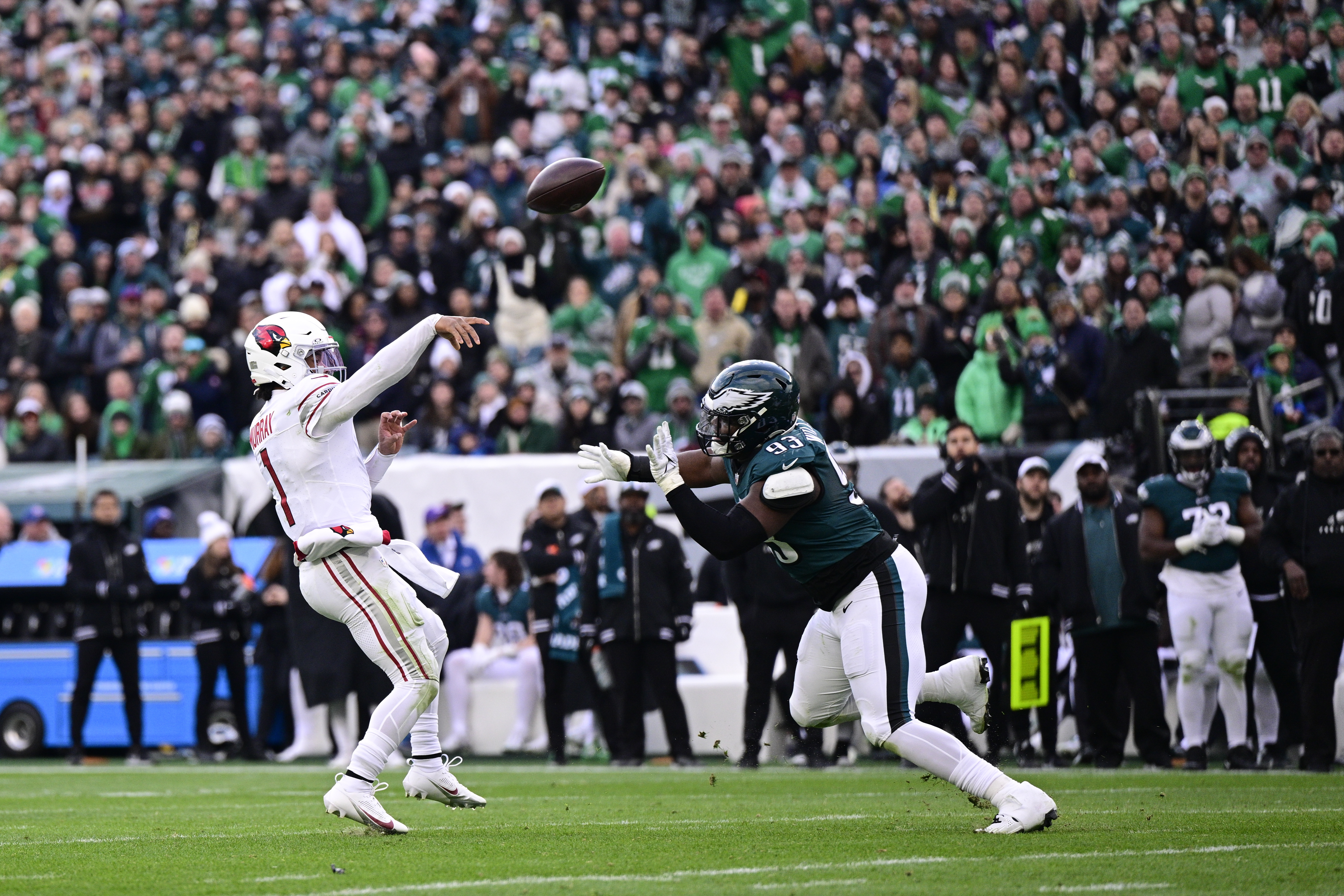 Arizona Cardinals quarterback Kyler Murray, left, throws a touchdown pass over the coverage of Philadelphia Eagles defensive tackle Milton Williams during the second half of an NFL football game, Sunday, Dec. 31, 2023, in Philadelphia. 