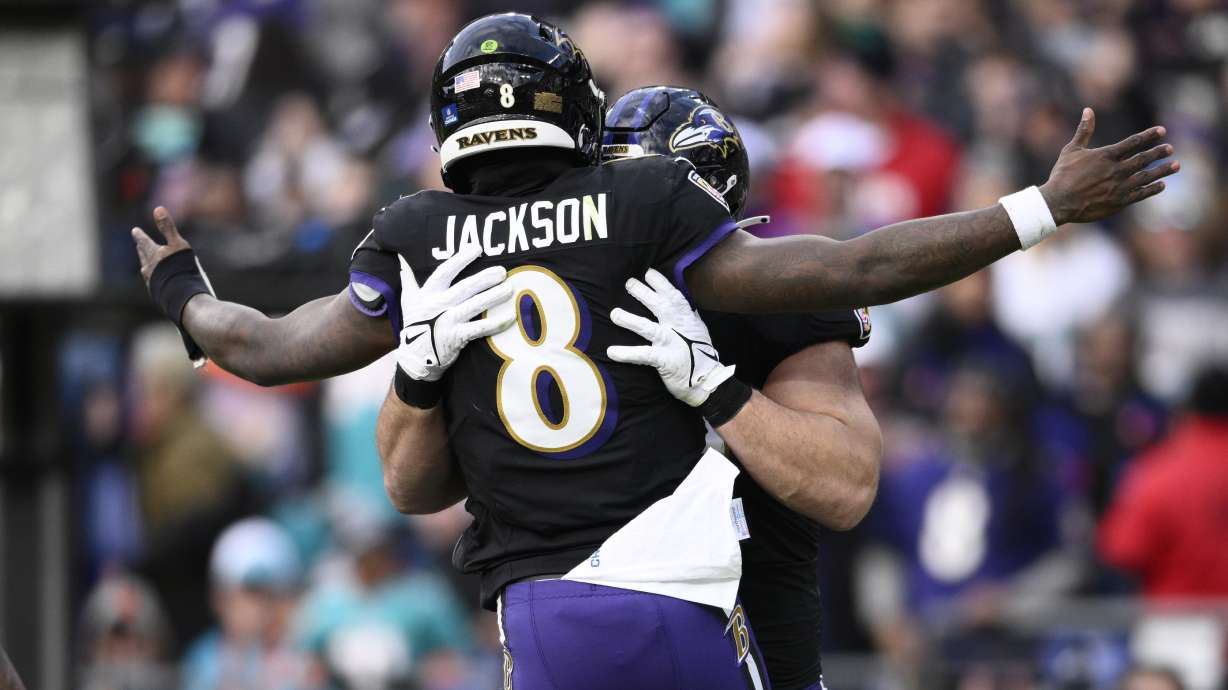 Baltimore Ravens quarterback Lamar Jackson (8) celebrates with Patrick Ricard after their tocudhown against the Miami Dolphins during the second half of an NFL football game in Baltimore, Sunday, Dec. 31, 2023.