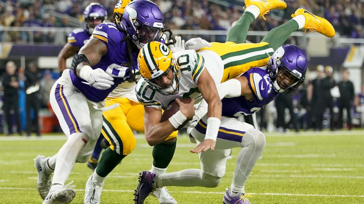 Green Bay Packers' Jordan Love dives into the end zone for a touchdown during the first half of an NFL football game against the Minnesota Vikings Sunday, Dec. 31, 2023, in Minneapolis.
