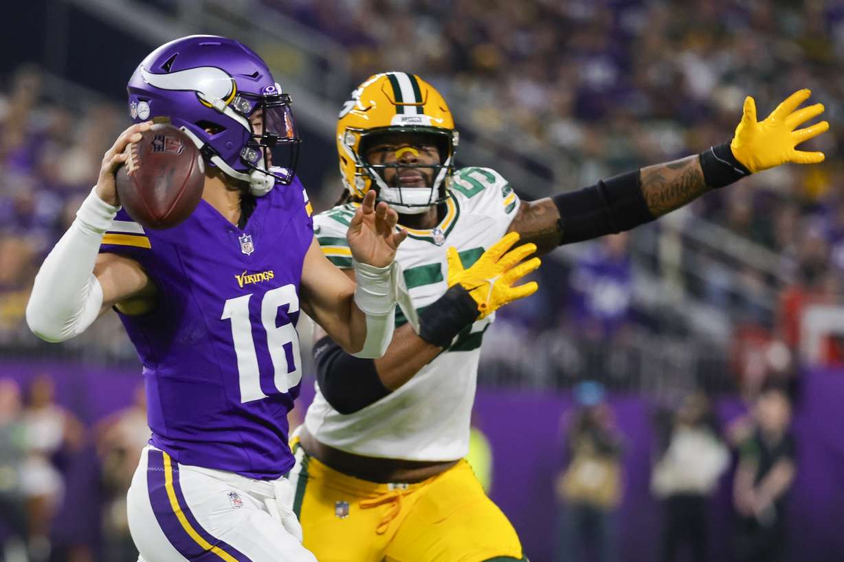 Minnesota Vikings' Jaren Hall looks to pass with Green Bay Packers' Rashan Gary rushing during the first half of an NFL football game Sunday, Dec. 31, 2023, in Minneapolis.