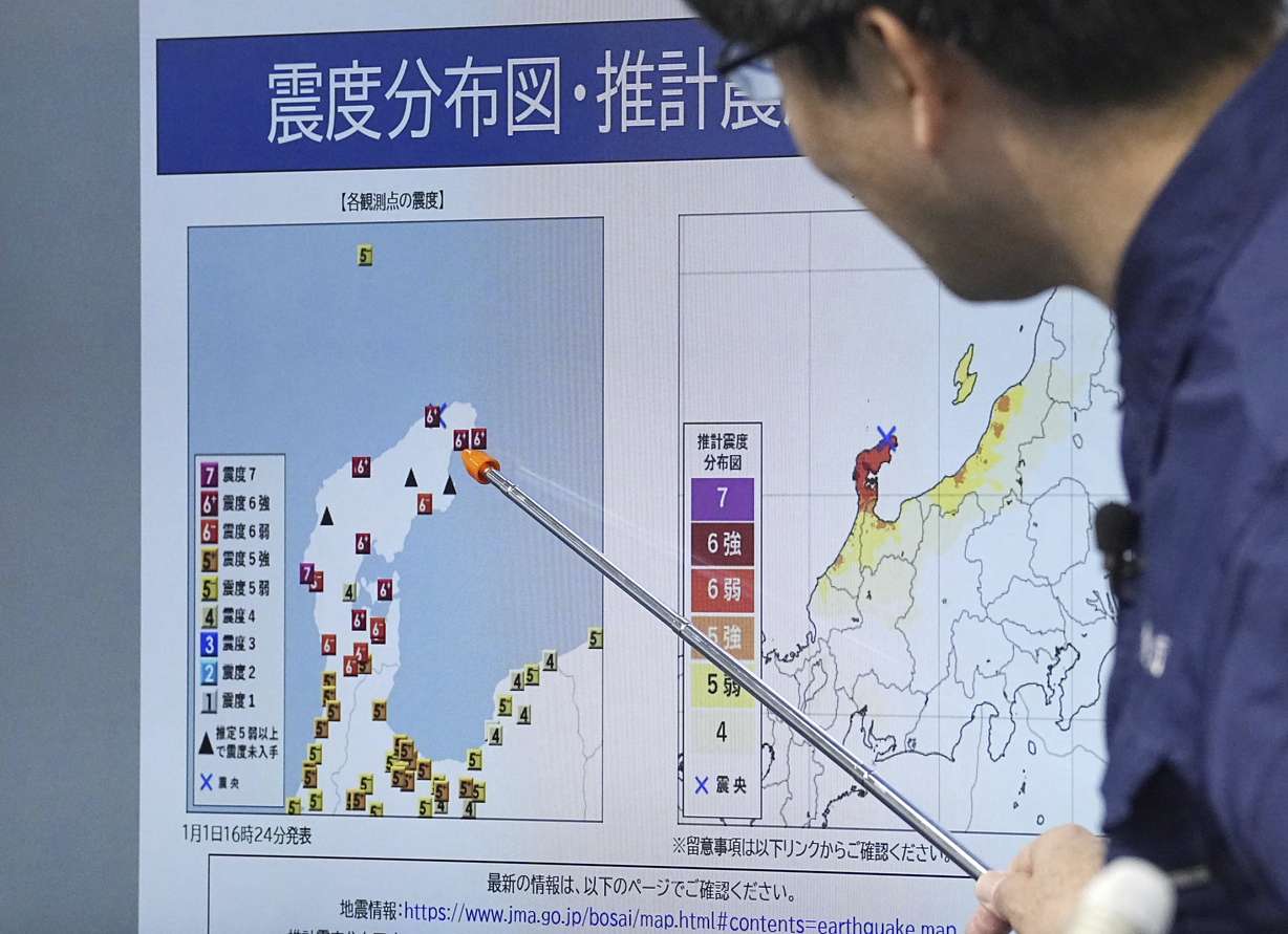 A staff member of Japan Meterological Agency speaks at a press conference in Tokyo on Monday following an earthquake. Japan issued tsunami alerts and told people to evacuate seaside areas after a series of strong quakes on its western coastline Monday.