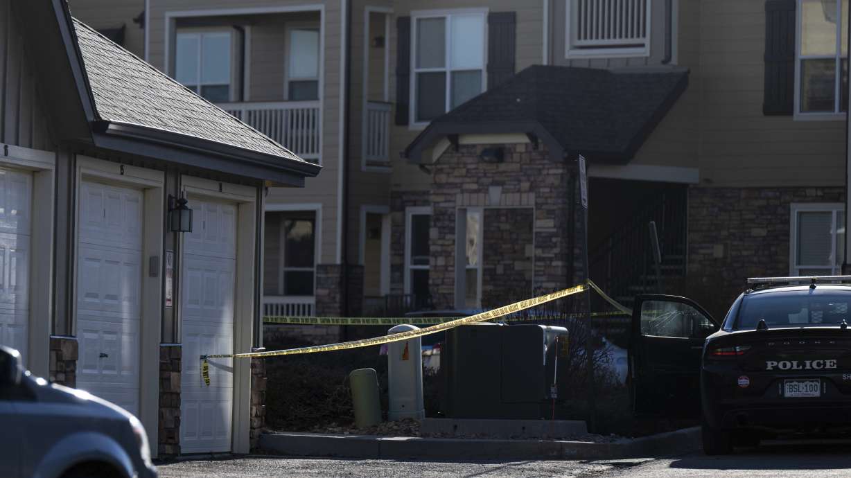 A Colorado mother suspected of killing two of her young children and wounding a third was arrested Saturday in the United Kingdom, authorities said.