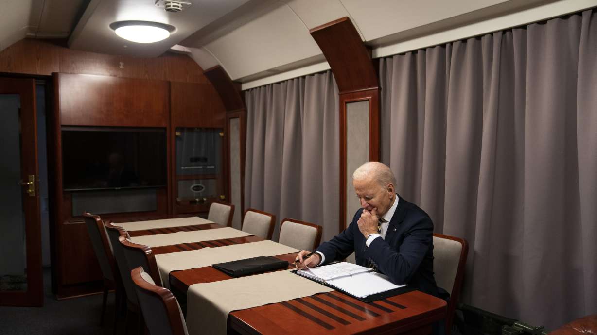 President Joe Biden sits on a train as he goes over his speech marking the one-year anniversary of the war in Ukraine after a surprise visit with Ukrainian President Volodymyr Zelenskyy on Feb. 20, 2023, in Kyiv.
