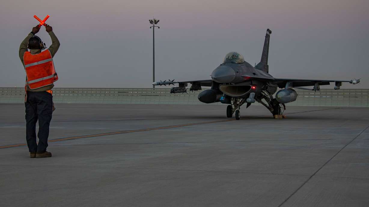 An airman guides an F-16 Fighting Falcon during training at Al-Udeid Air Base, Qatar, in January 2022. The United States has quietly reached an agreement that extends its military presence at a sprawling base in Qatar for another 10 years.