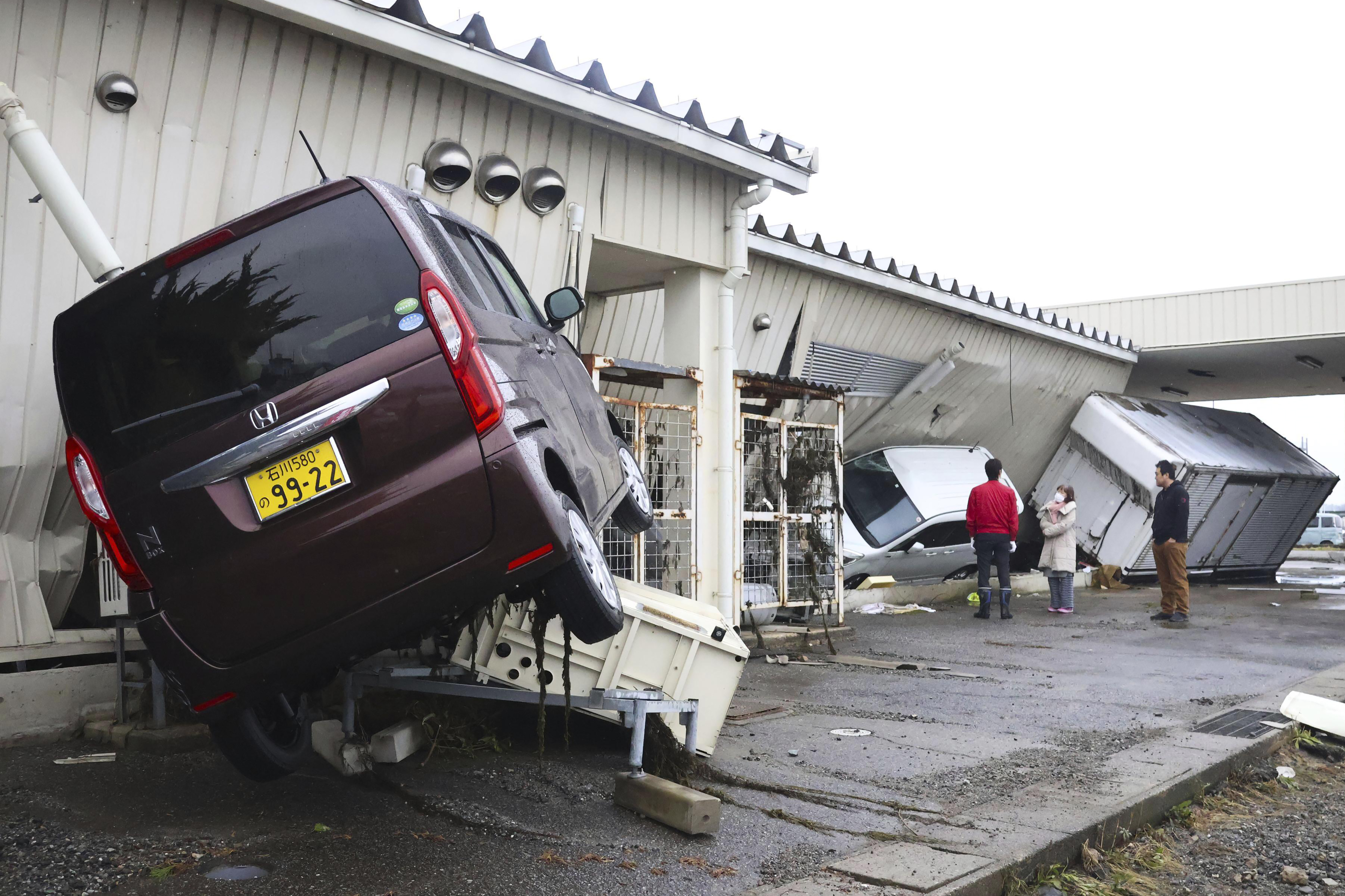 Damaged cars are seen after earthquakes and tsunami in Suzu, Ishikawa prefecture, Japan, Wednesday.