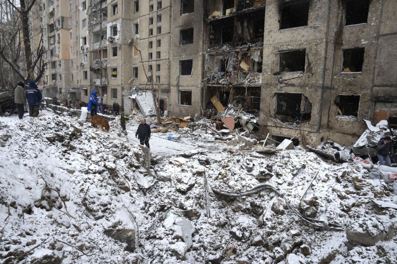 A crater of an explosion is seen next to an apartment building destroyed after Tuesday's Russian attack in Kyiv, Ukraine, Wednesday.