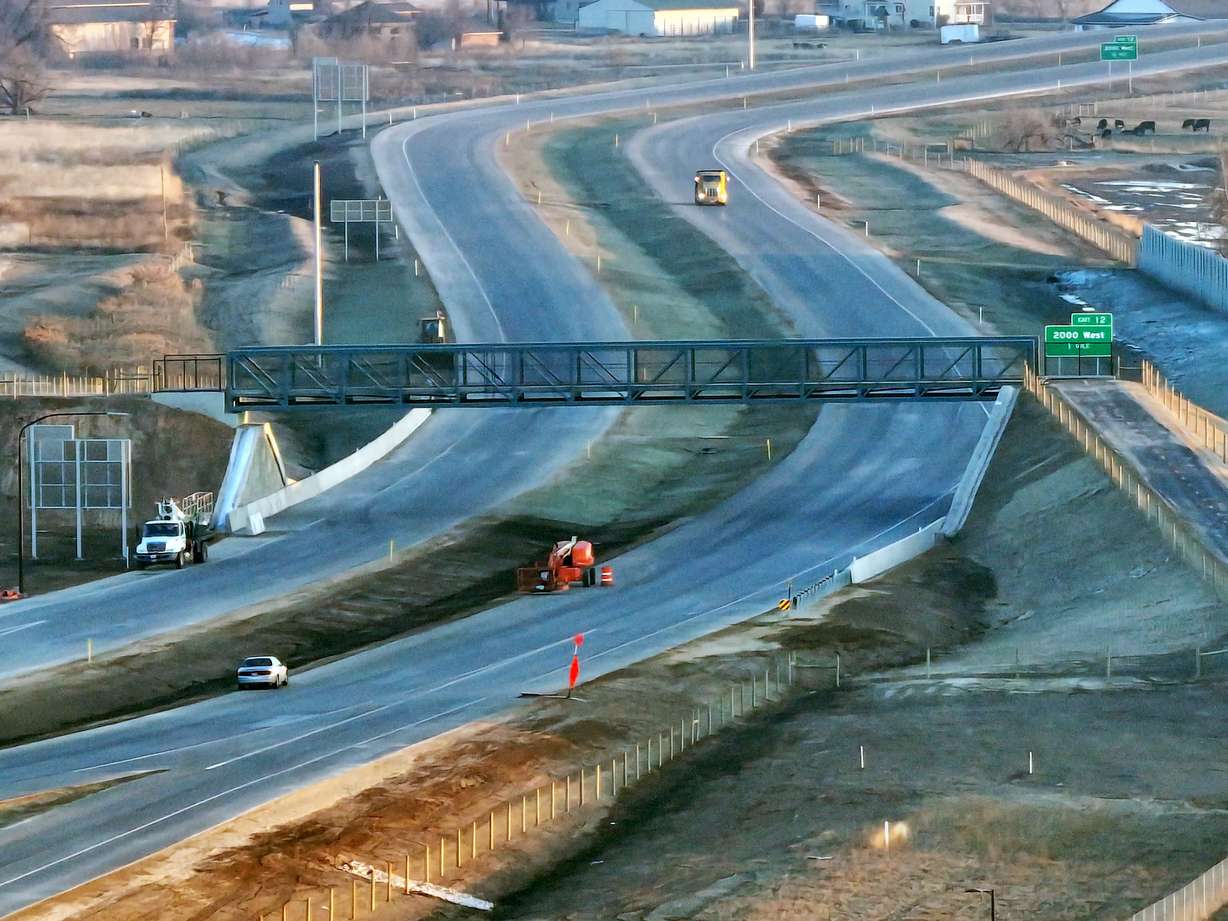 Workers operate heavy equipment in Syracuse as they work on the West Davis Corridor, which connects western Davis County communities with a viable alternative to I-15, on Tuesday.