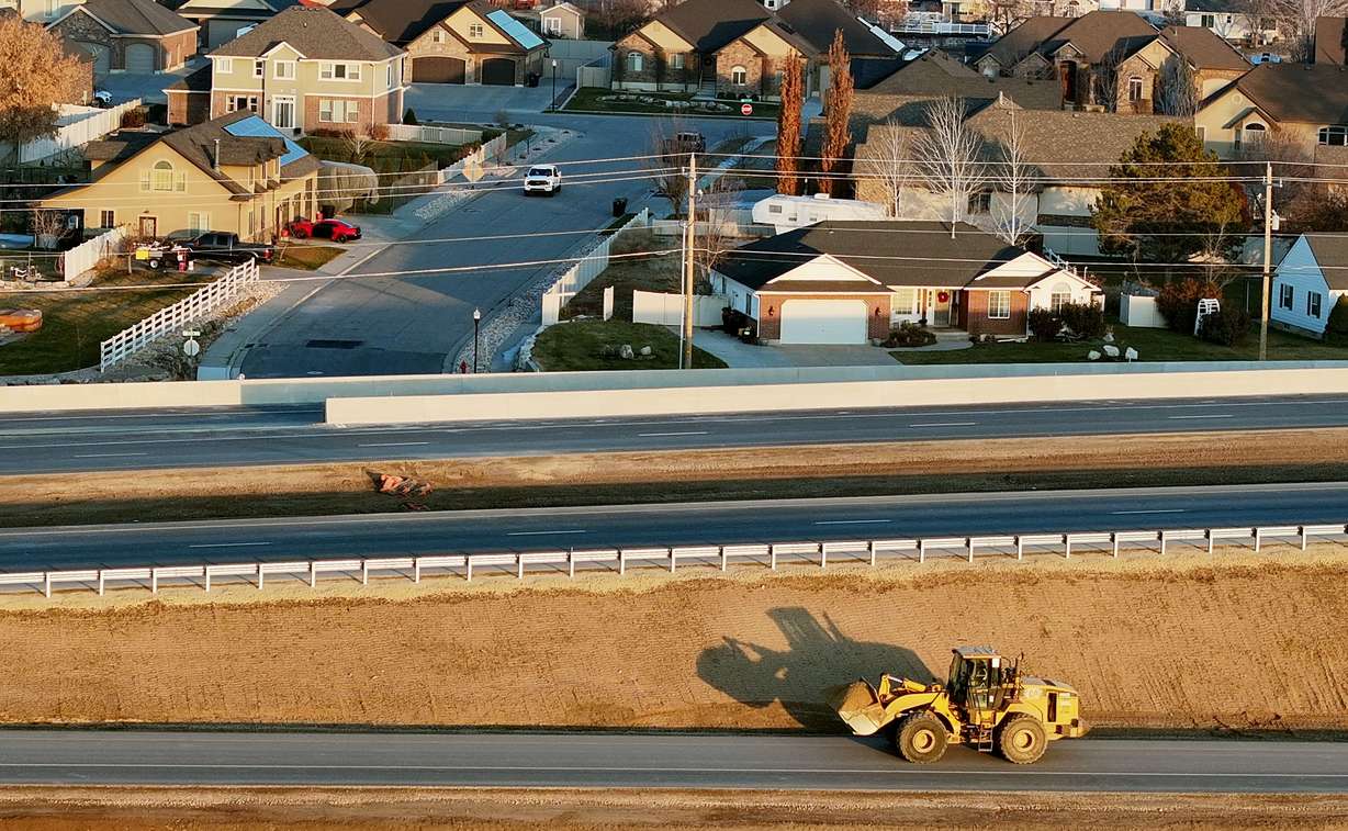 A worker drives a loader with a load of dirt in Syracuse as they work on the West Davis Corridor, which connects western Davis County communities with a viable alternative to I-15, on Tuesday.