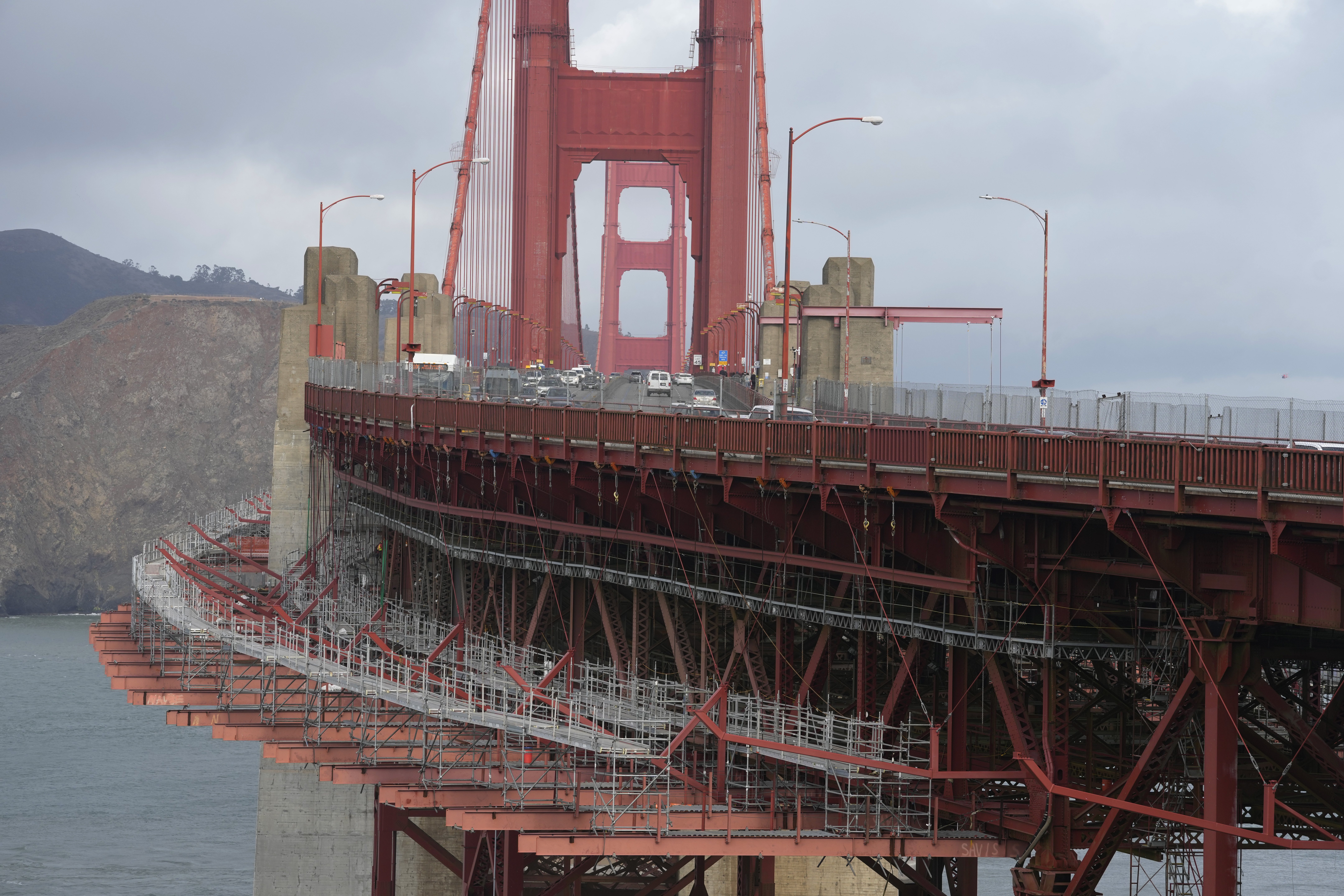 A suicide deterrent net is seen under construction on the Golden Gate Bridge in San Francisco, Dec. 6, 2023. The barrier at the bridge is near completion more than a decade after officials approved it. 